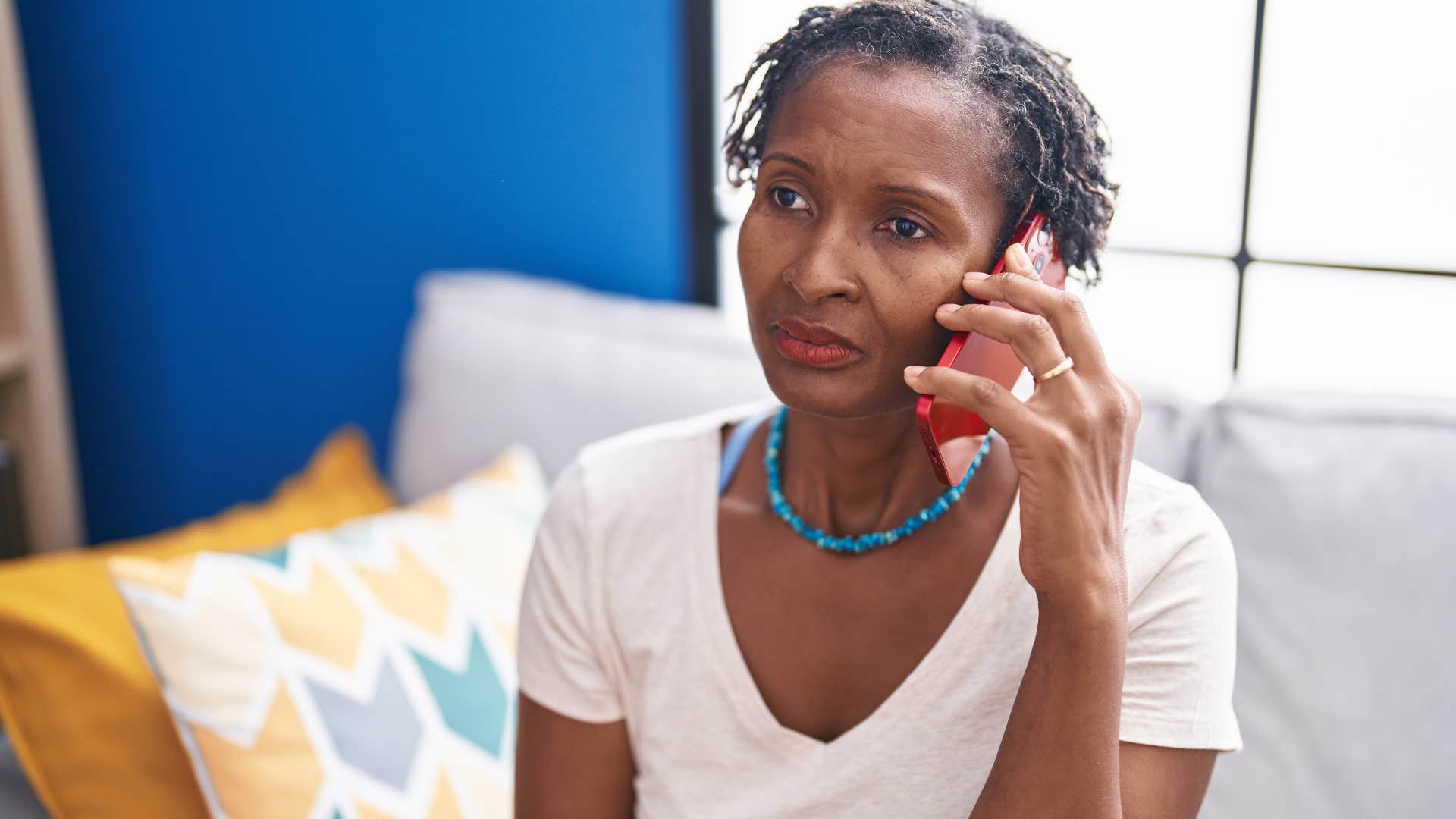 Woman who's protective of their time looking upset on the phone.
