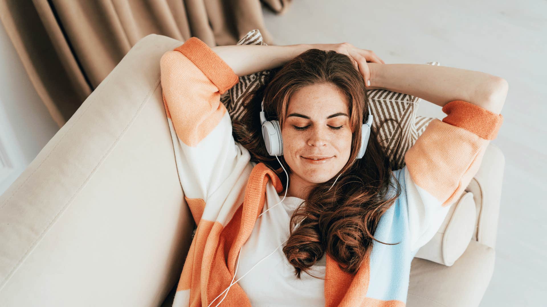 woman enjoying being home listening to music