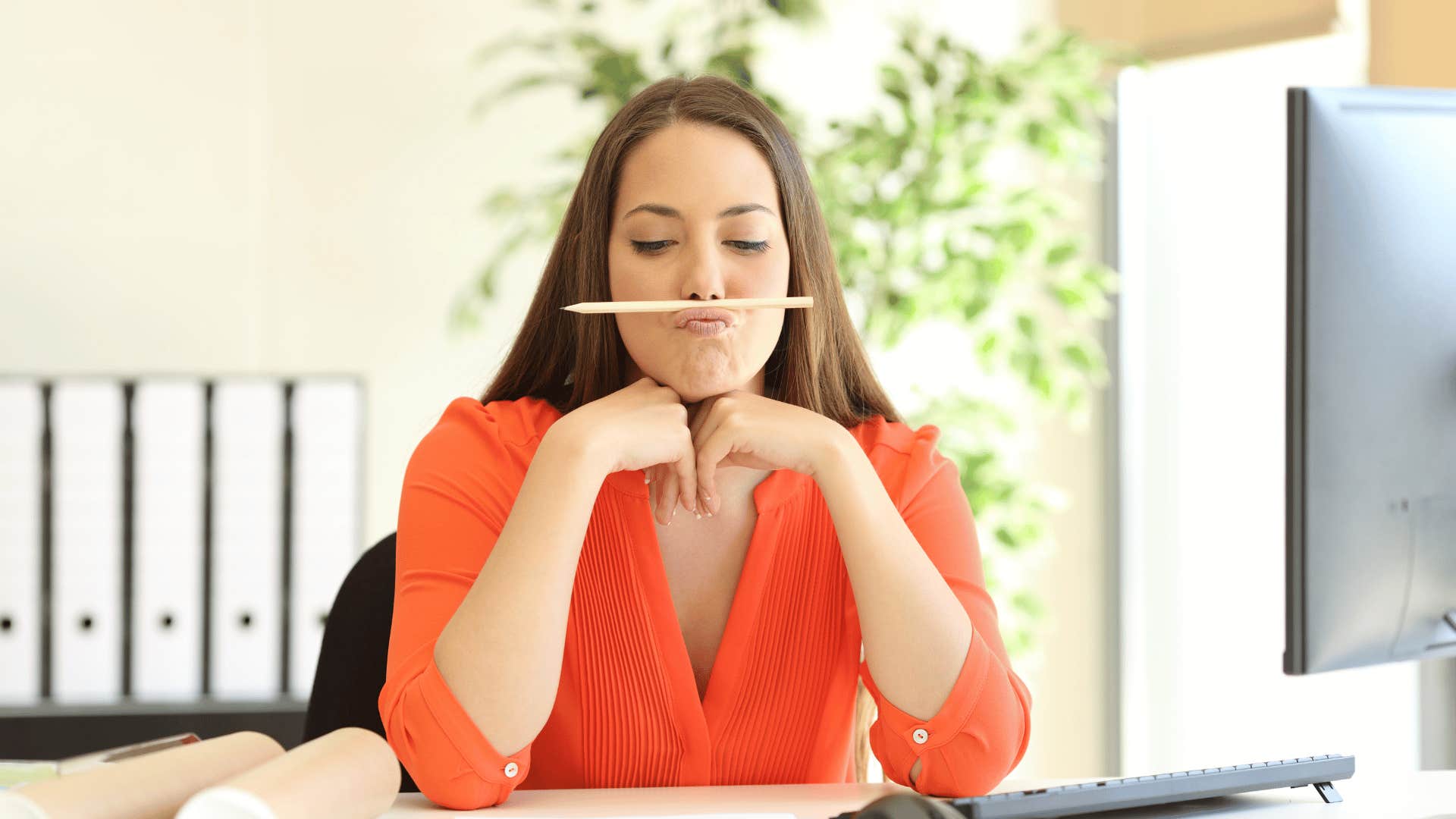 unfocused woman at work thinking about staying home all weekend