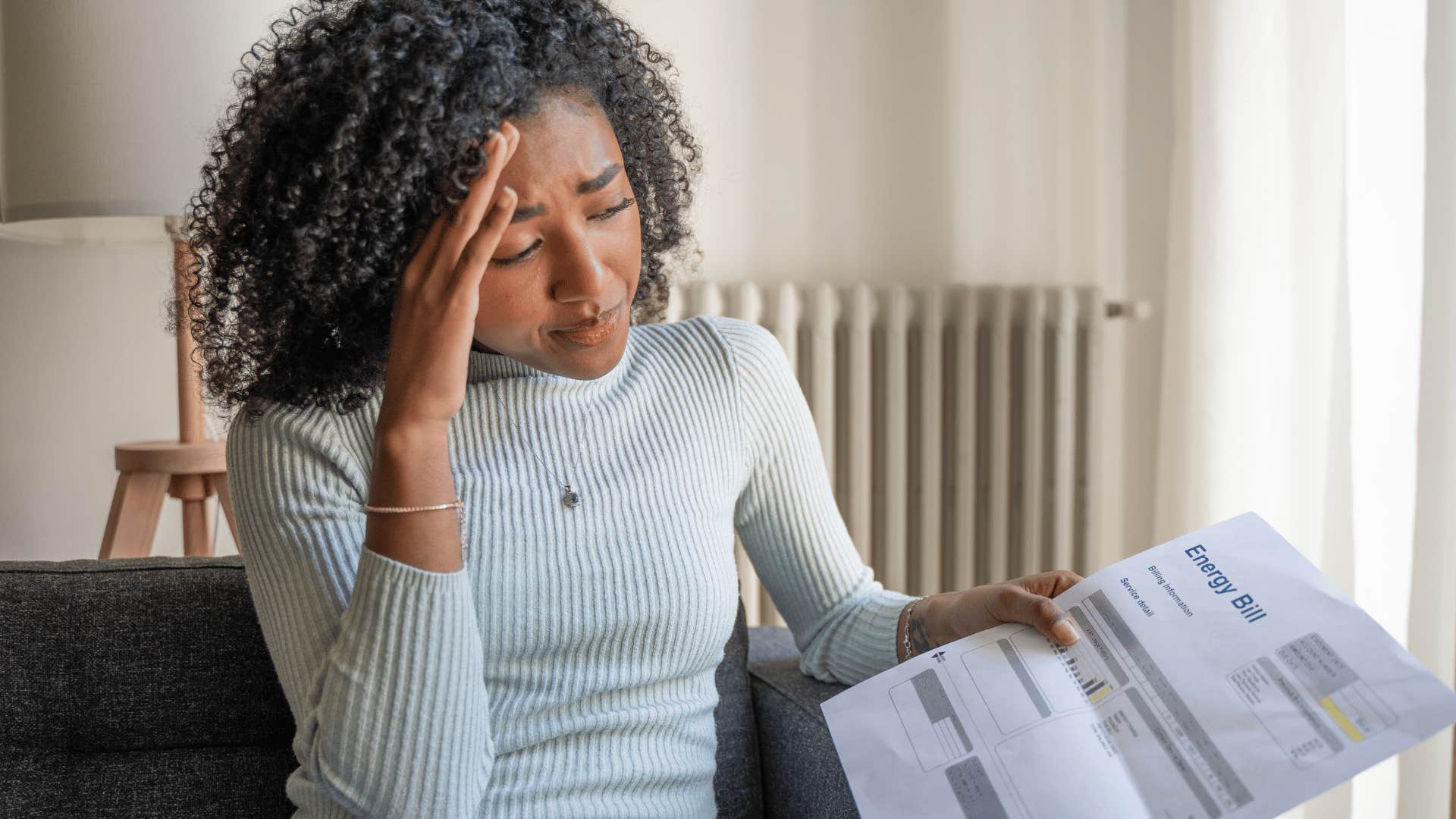 woman with avoidant tendencies looking at a bill