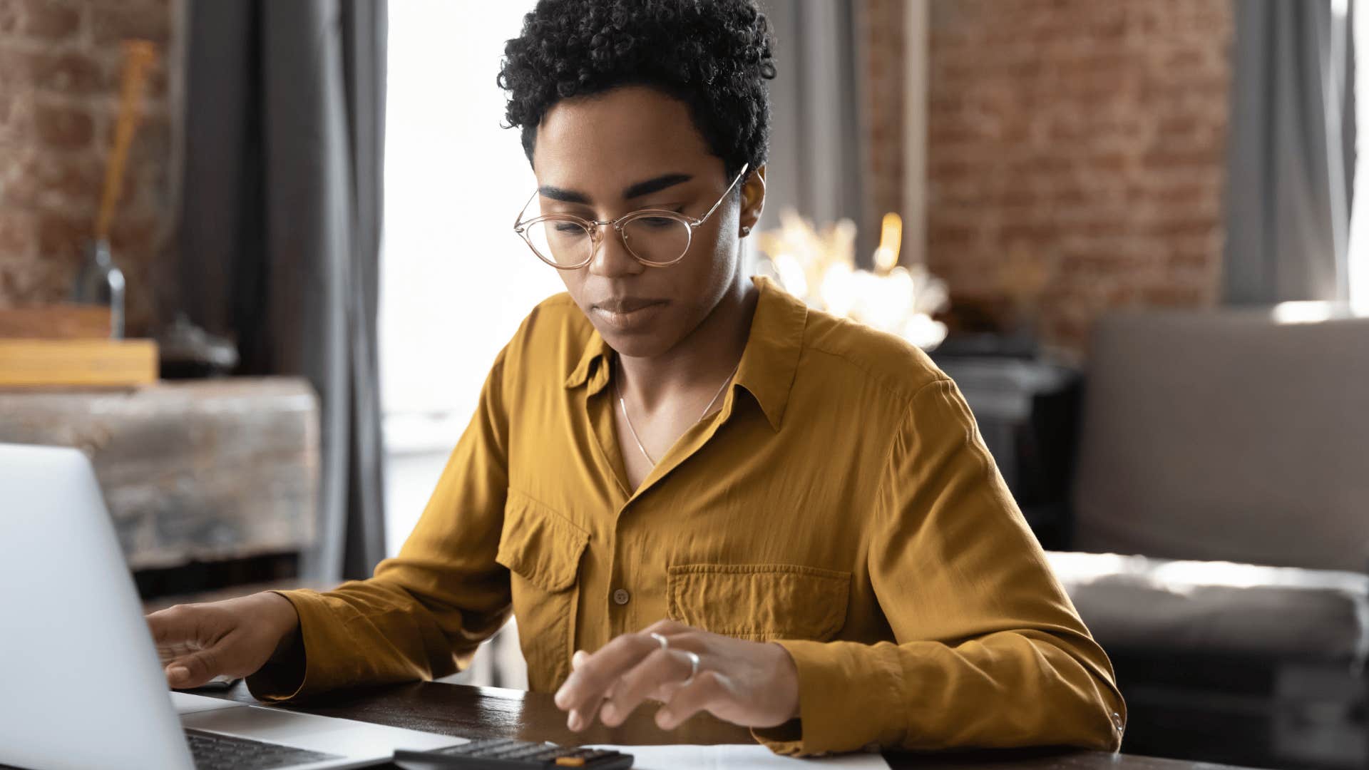 scared woman experiencing financial instability doing bills