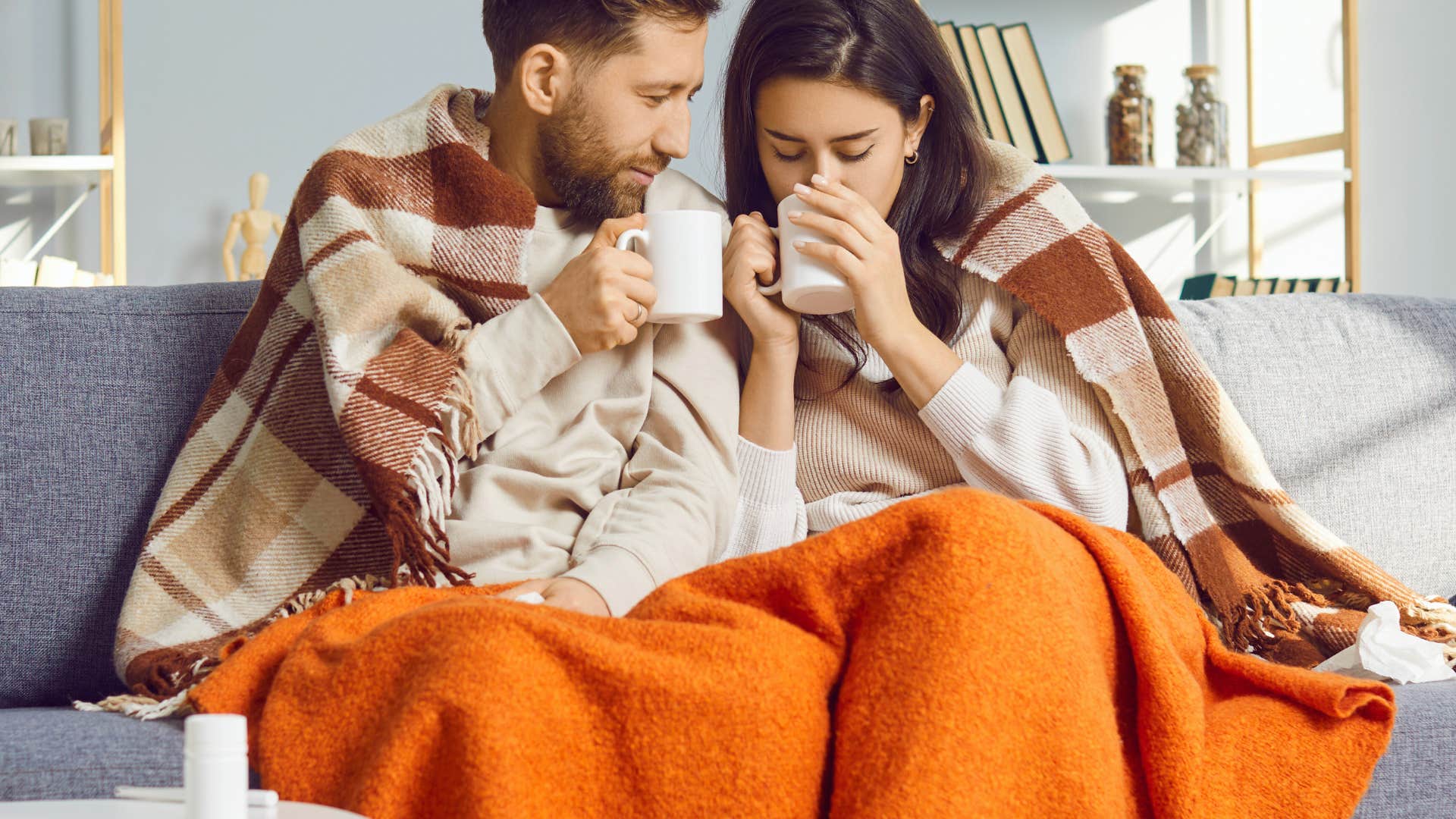 couple who hate going out sitting under their blankets at home