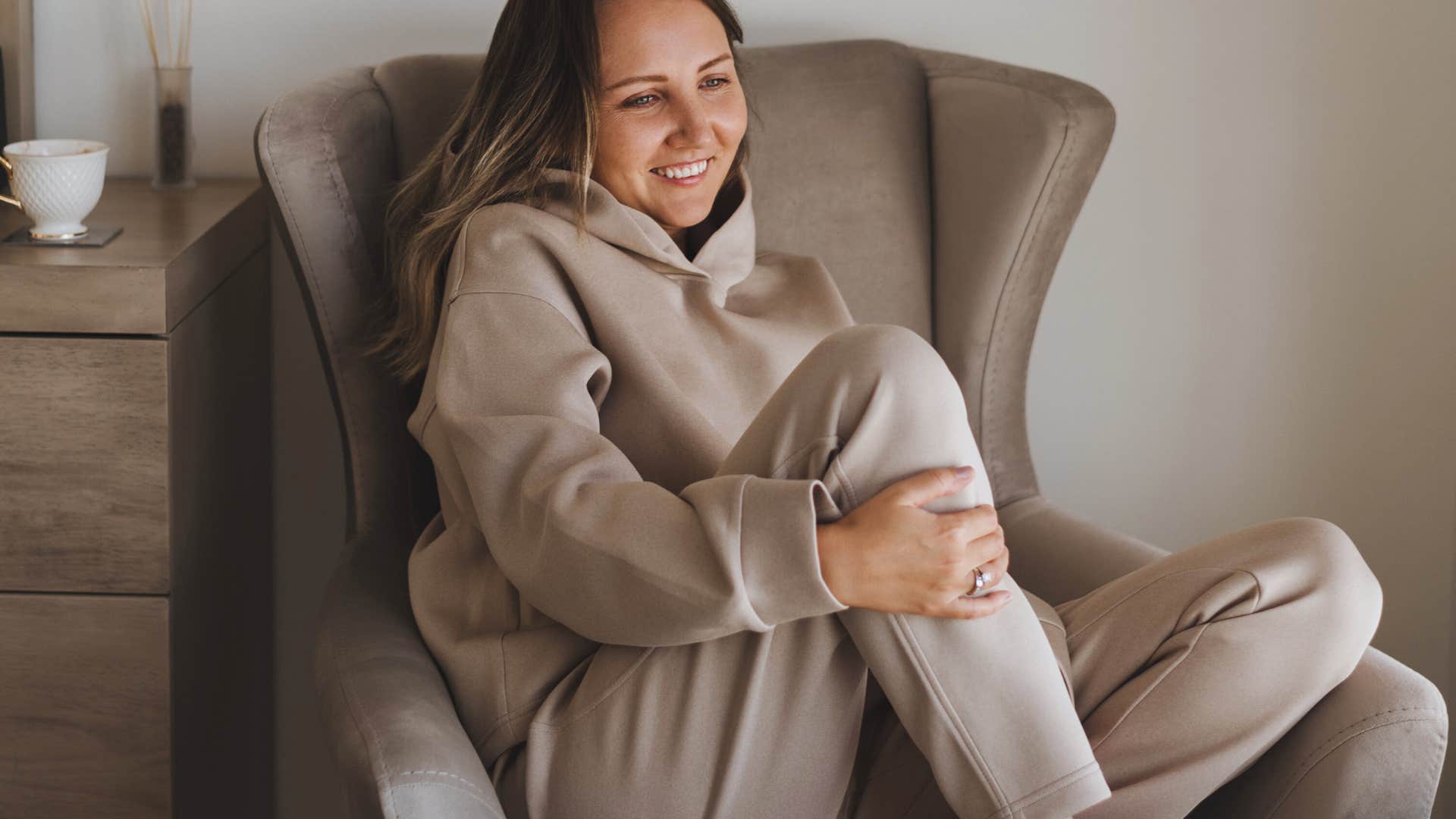 woman who hates going out sitting in a comfy chair at home