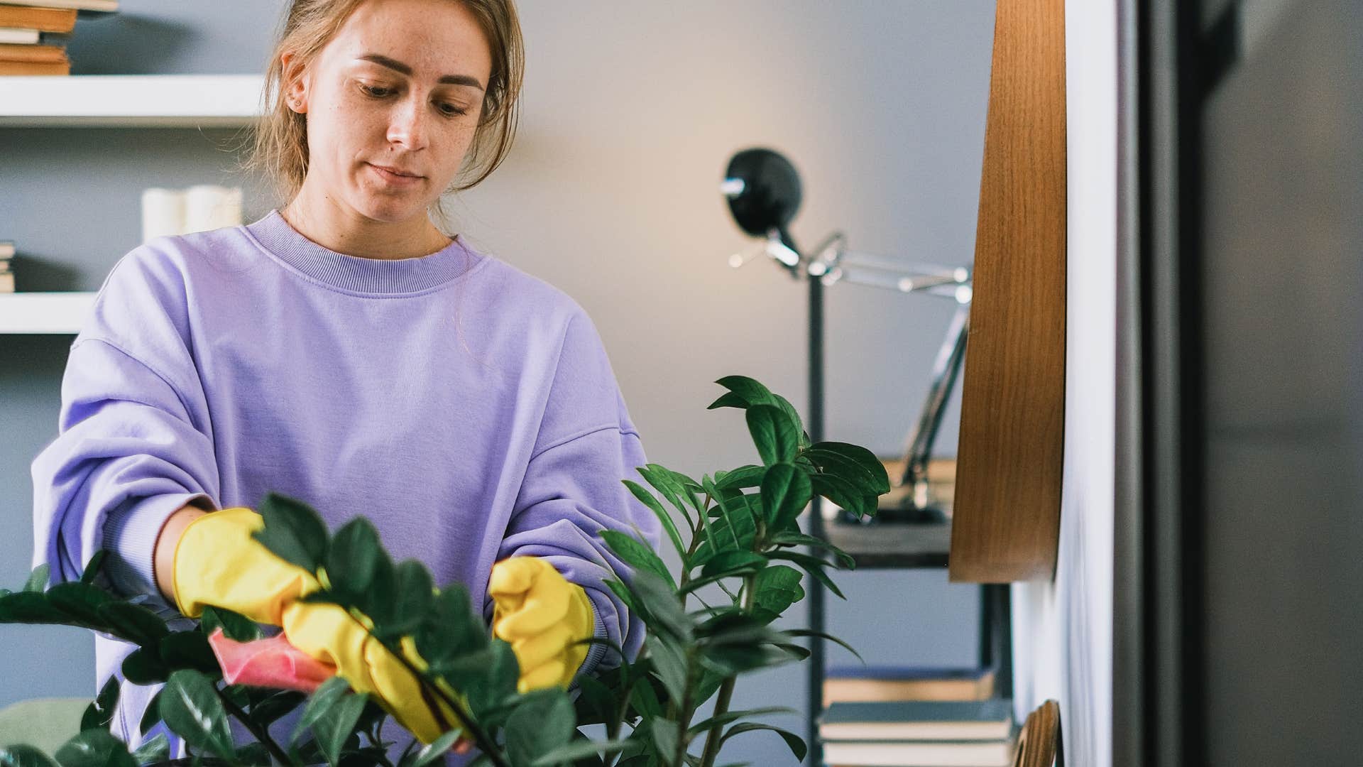 woman who hates going out watering plants in her home