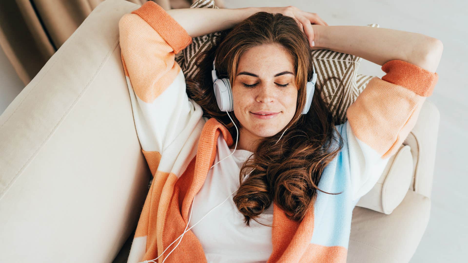 Woman who enjoys their solitude laying on the couch.
