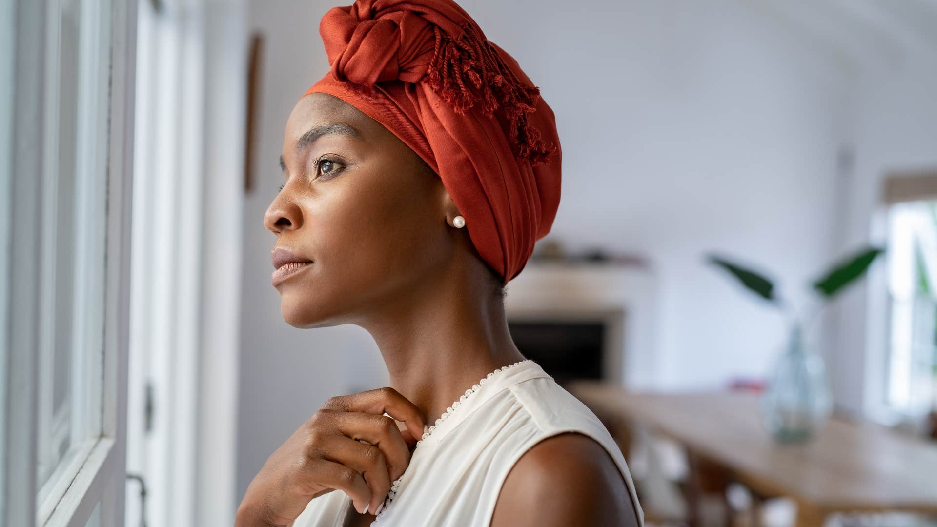 Woman who's not interested in superficial connections looking out a window.