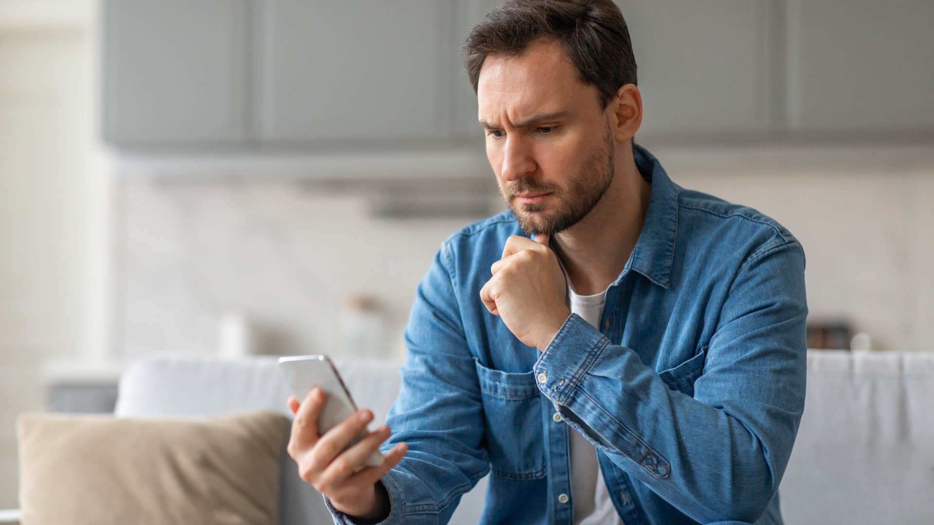 Man who's always one of the first ones to reach out looking at his phone.