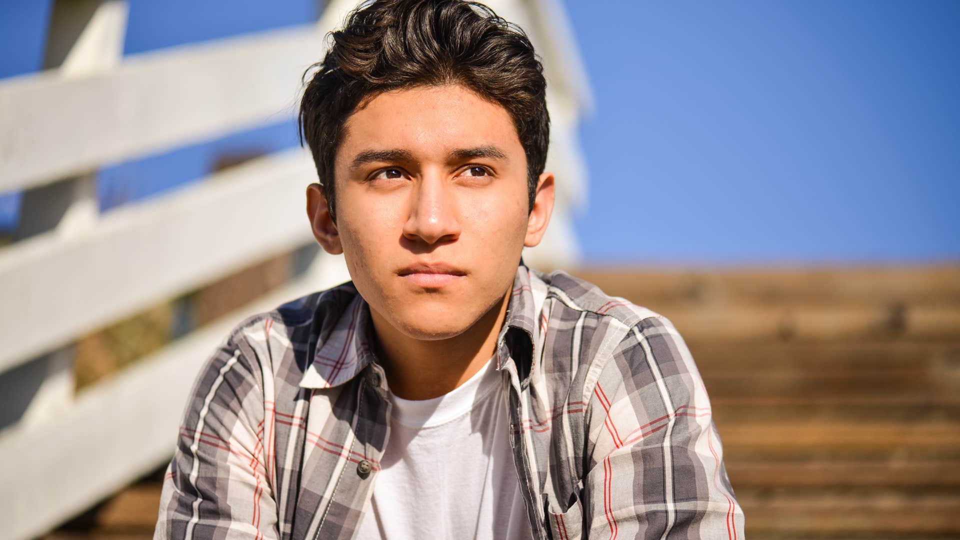 Young man sitting and thinking about how he had toxic friends in the past.