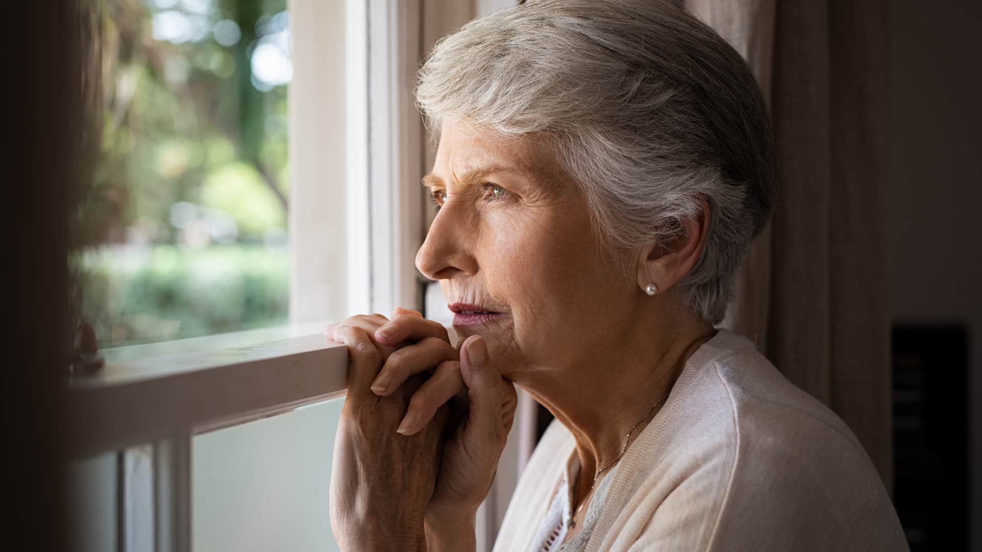 physically isolated women looking out the window