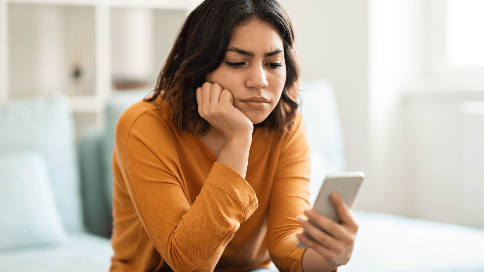 woman looking at phone waiting for bad friend to answer