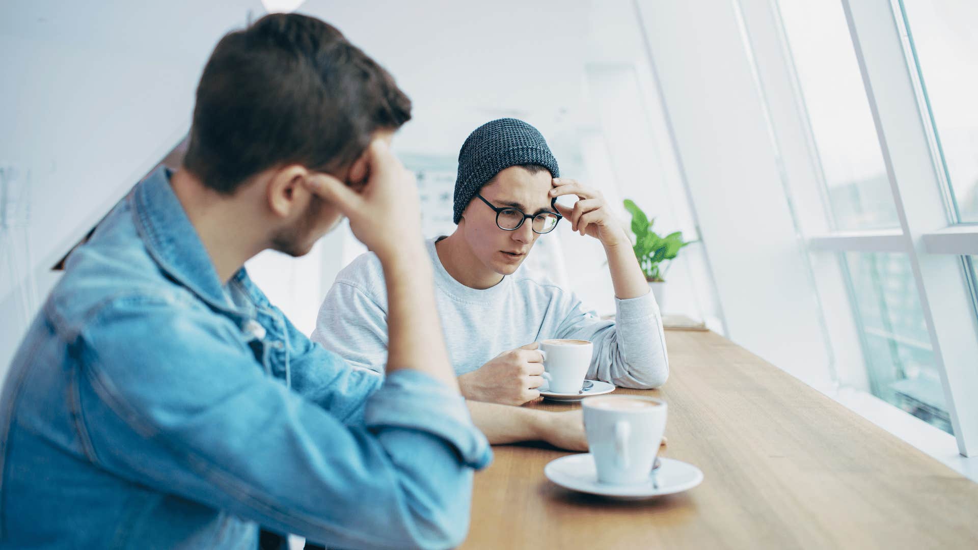two friends sitting in silence in stagnant friendship