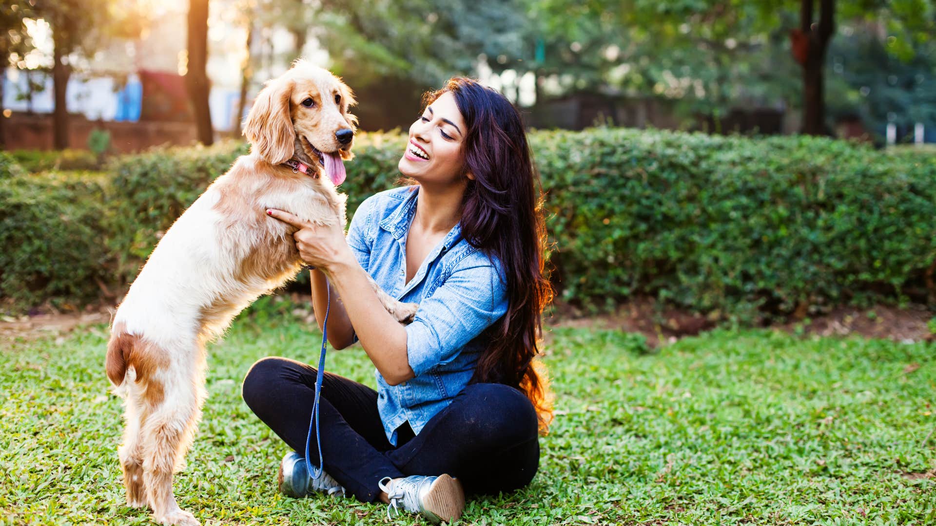 woman talking to dog smiling