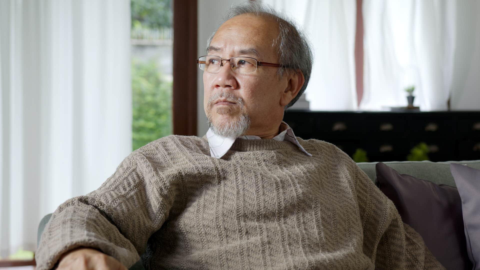 sad man with no support system sitting on couch