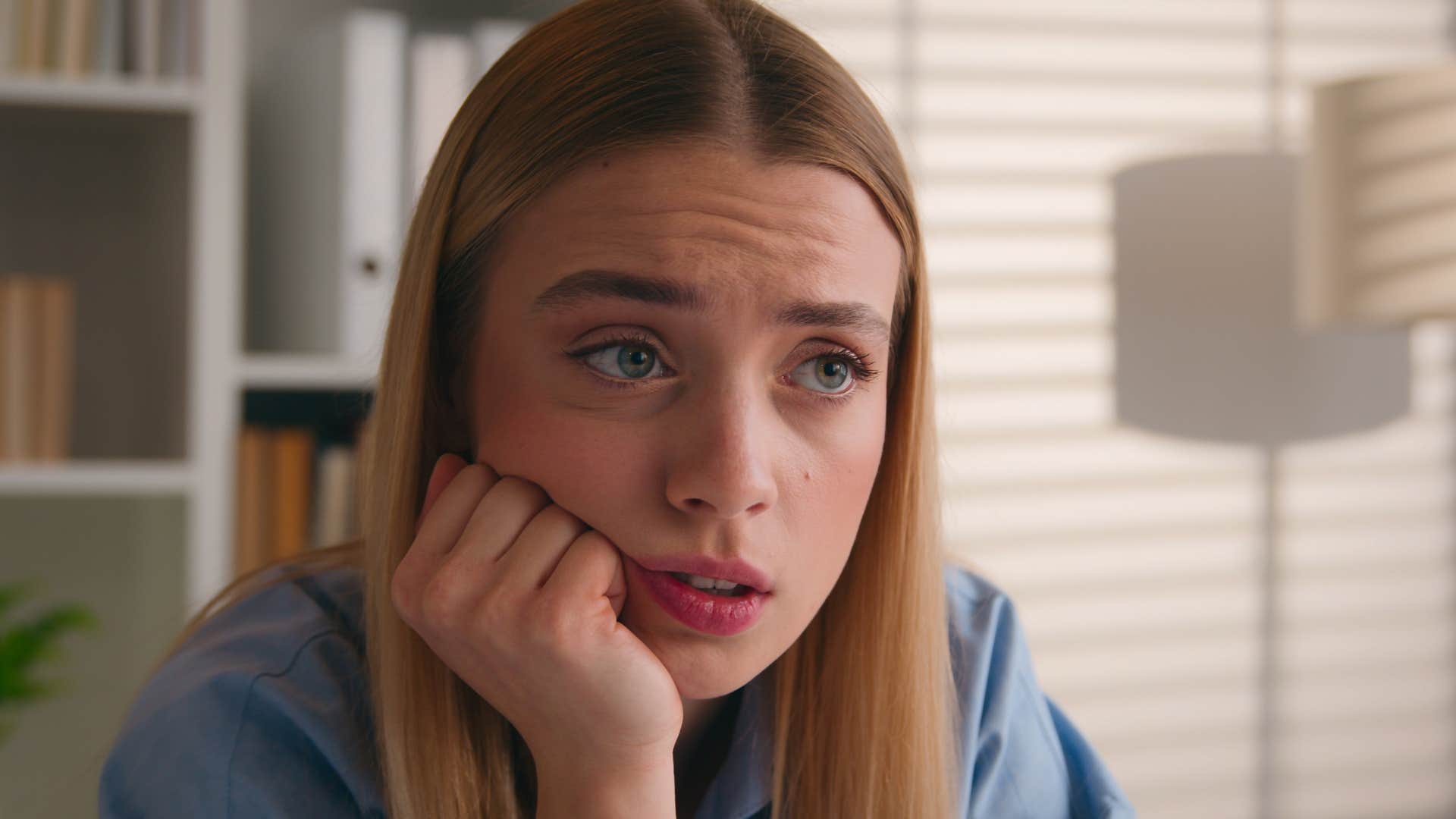 young woman looking afraid of rejection