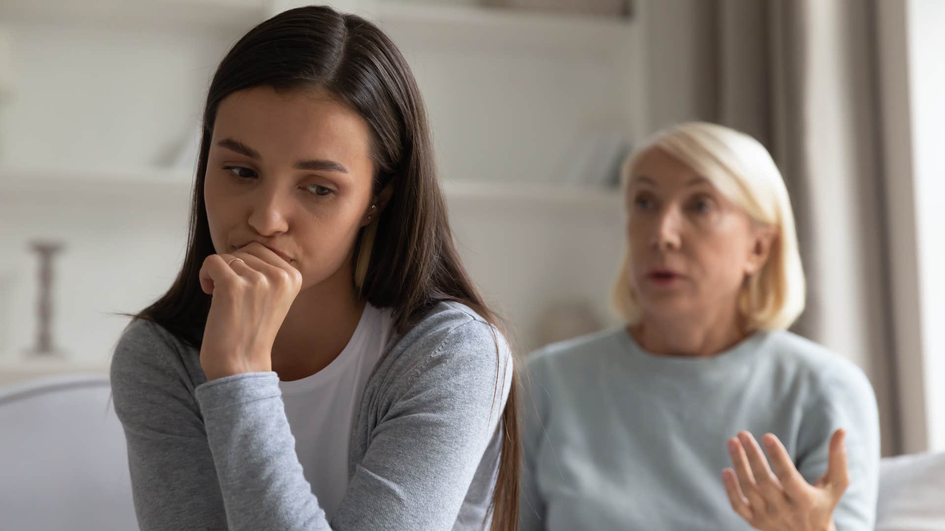 young woman turned away from mother who needs to be in control