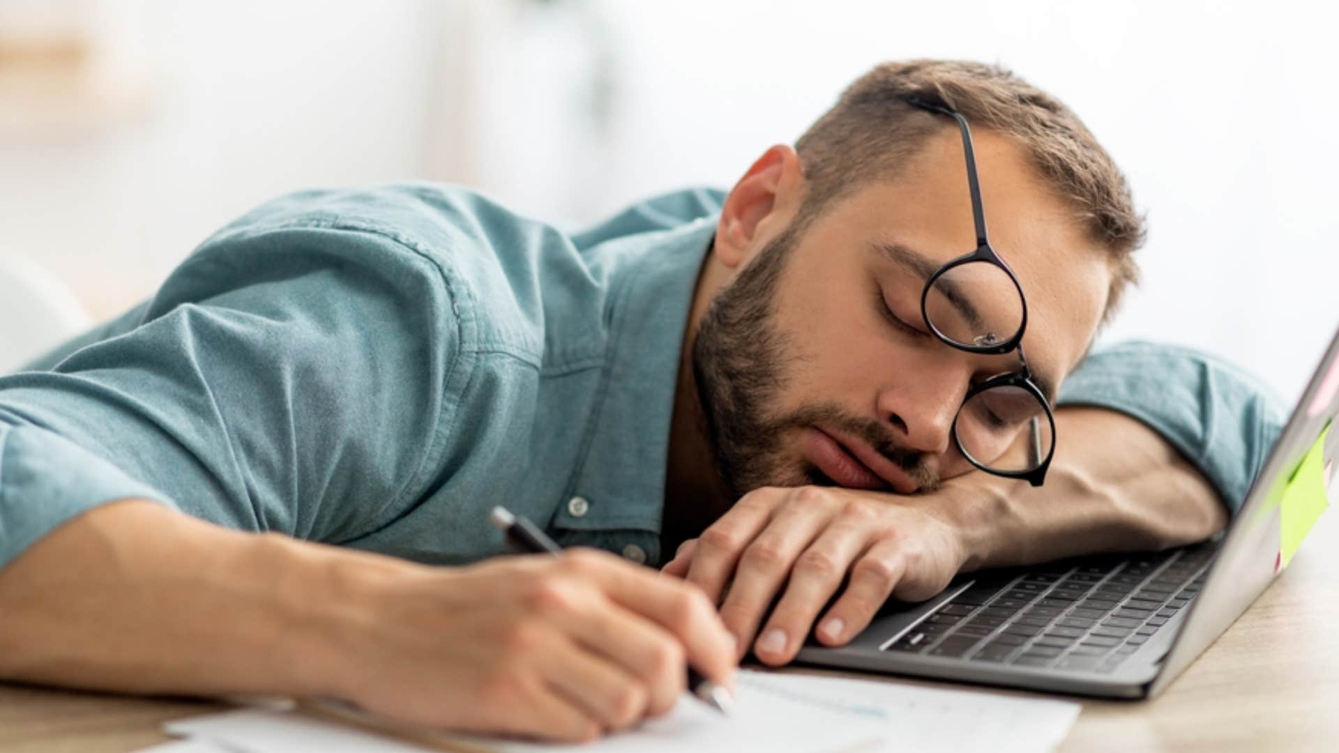 man feeling chronically burnout falling asleep at work