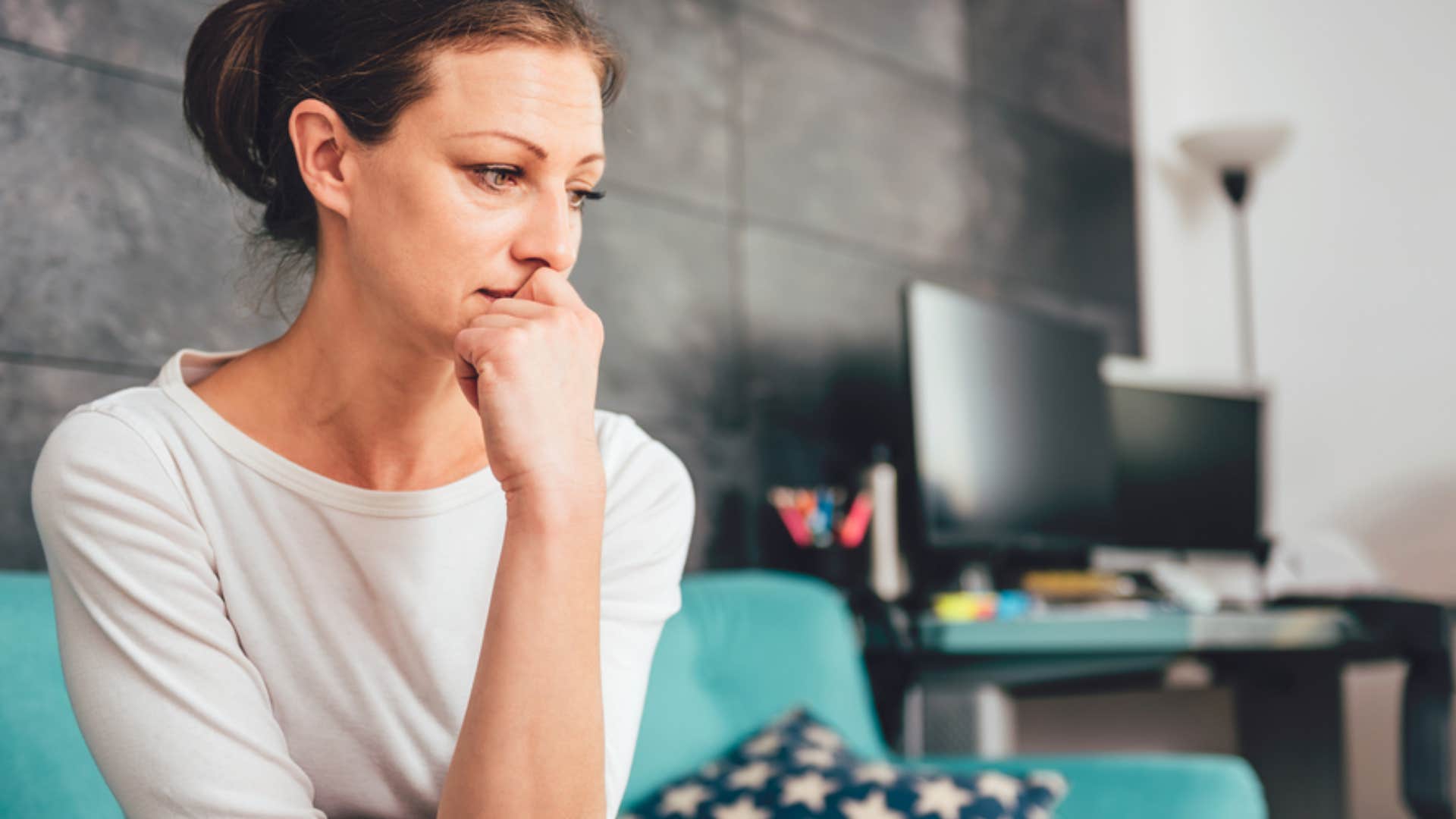 woman feeling emotionally exhausted sitting at home