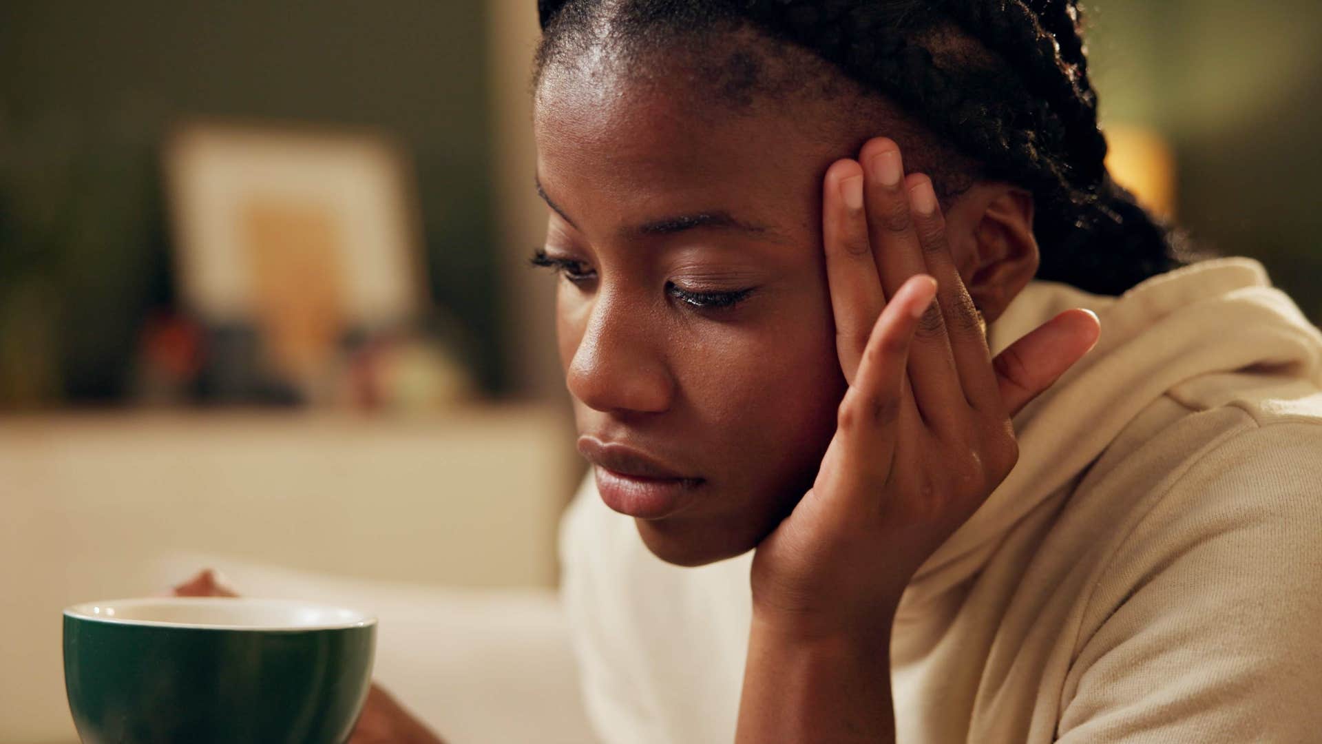 Woman battling constant anxiety holding her head.