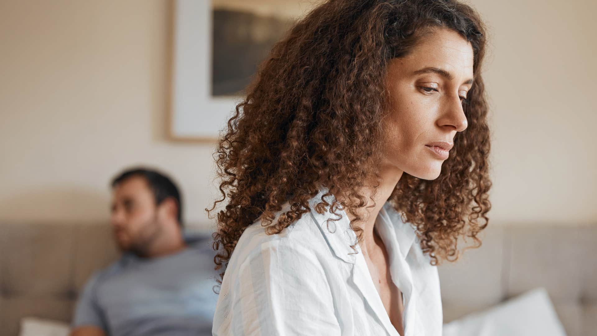 Woman with a strained relationship turned away from her partner.
