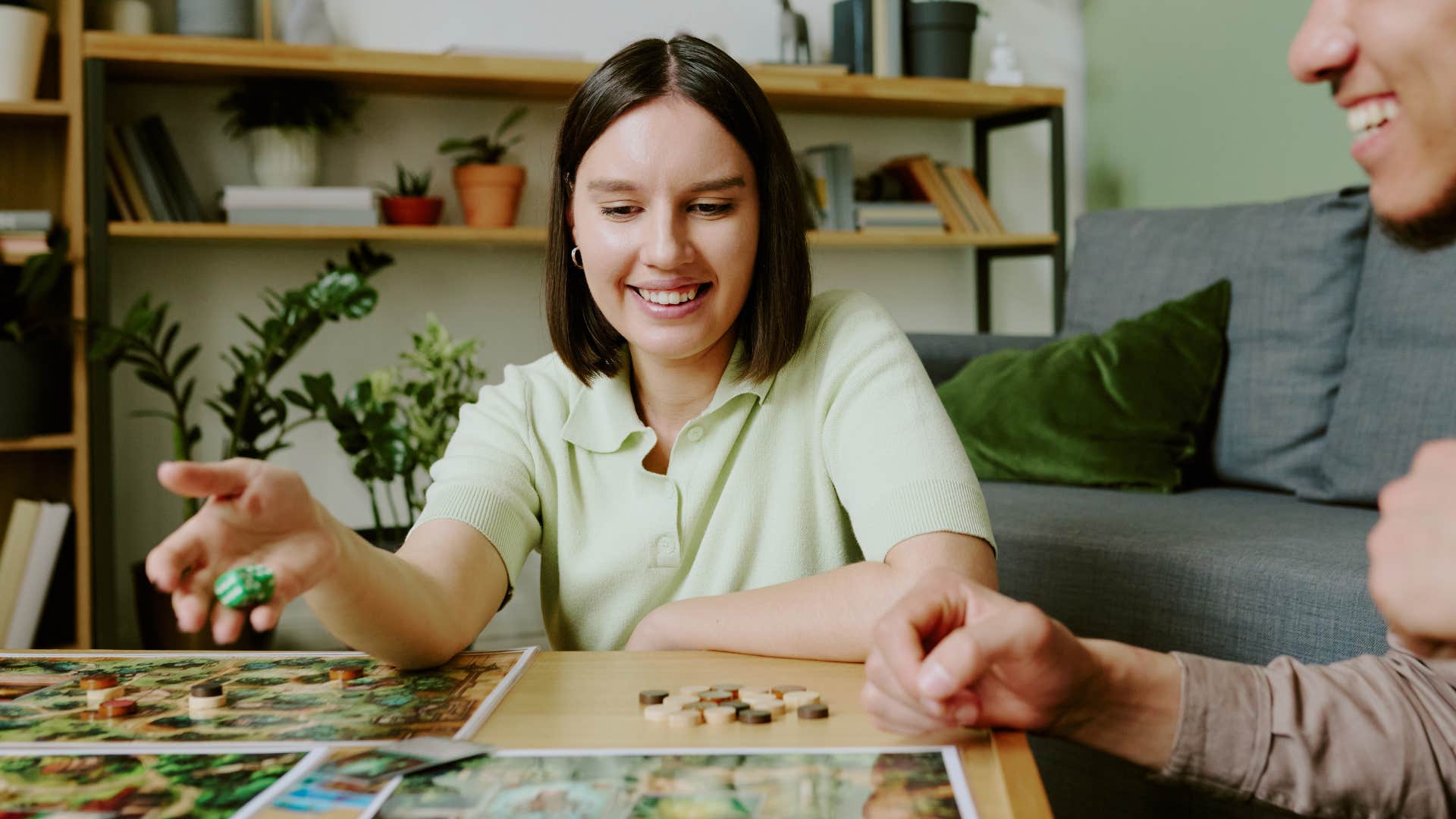 woman smiling and playing board games with partner
