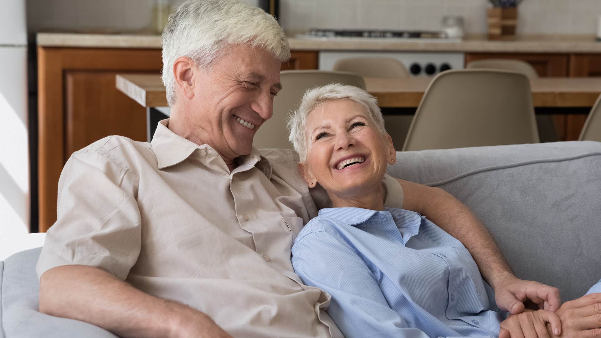 couple smiling and relaxing in a cozy conversation nook at home