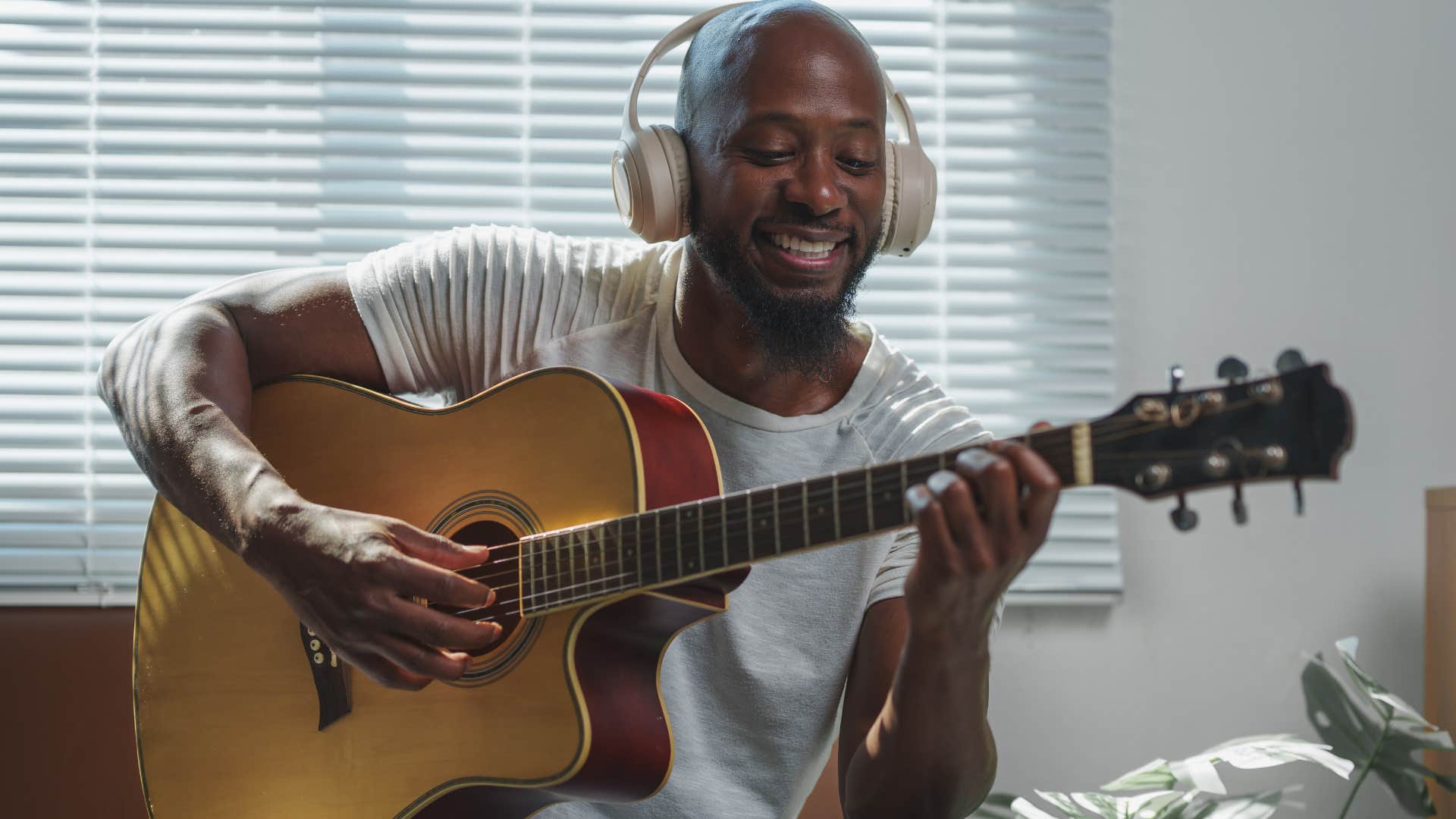 intelligent man playing guitar and singing