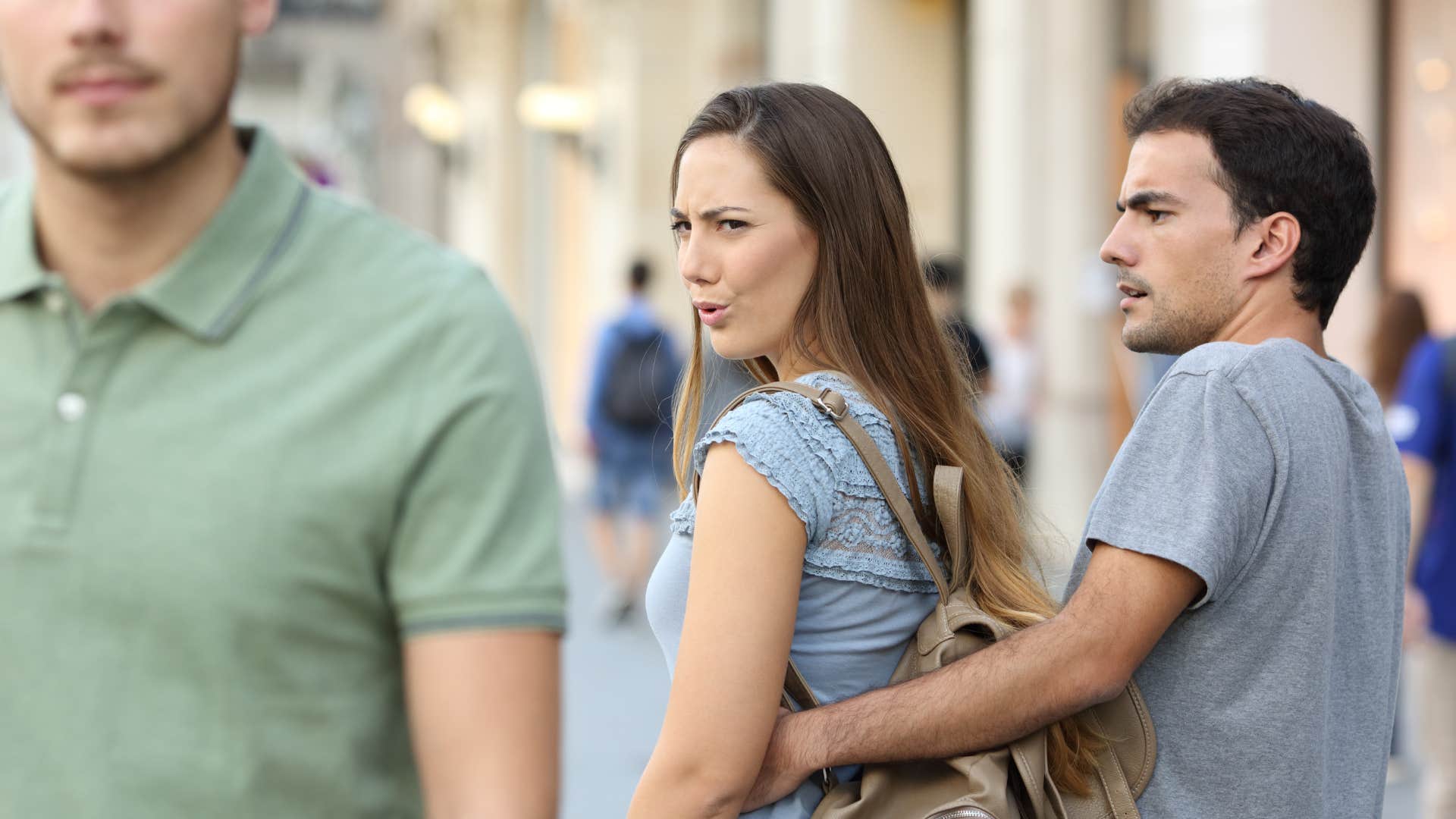upset woman with personality cues that may mean she's not being fully honest trying to make man jealous