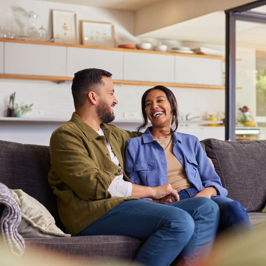 man who is totally irresistible to women talking to woman on couch