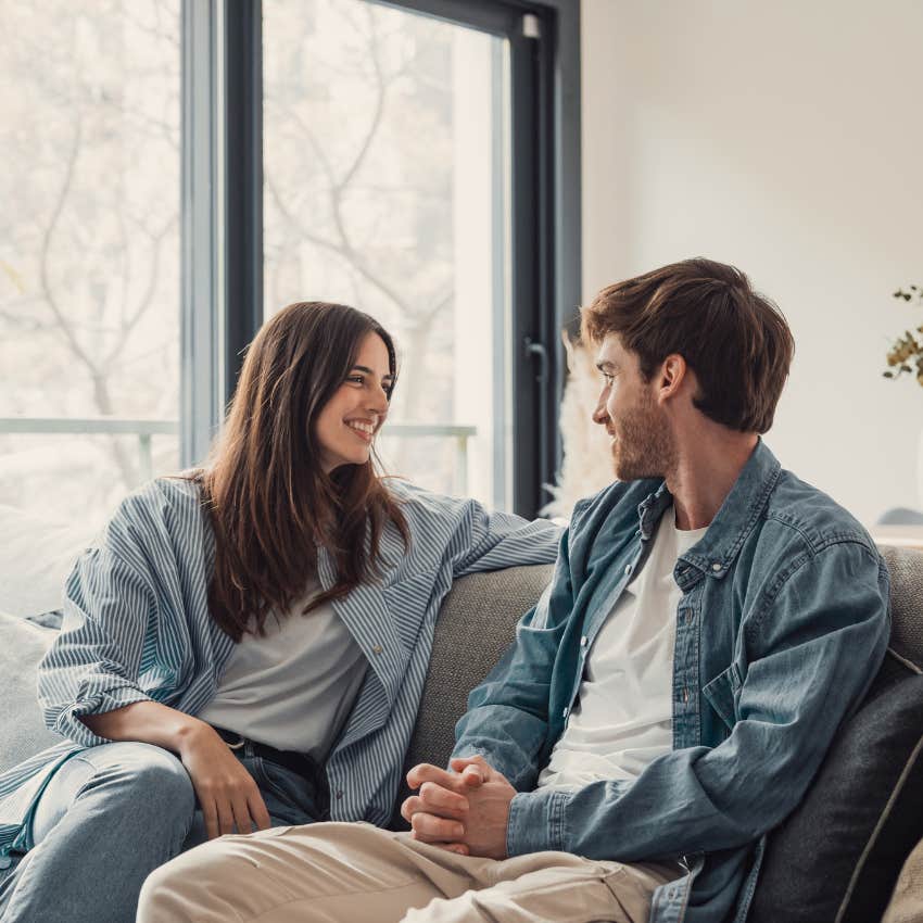 man who is totally irresistible to women talking to woman on couch