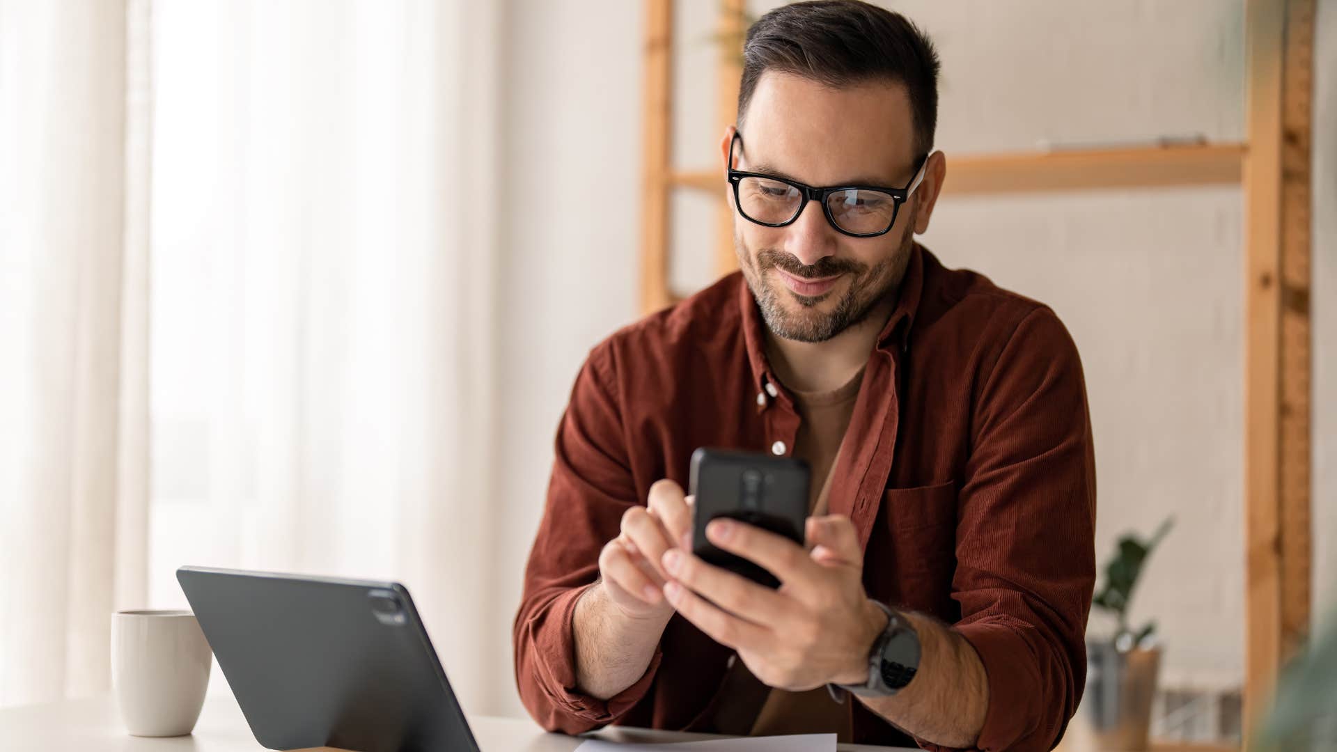 Happy man texting that they'll get together another time