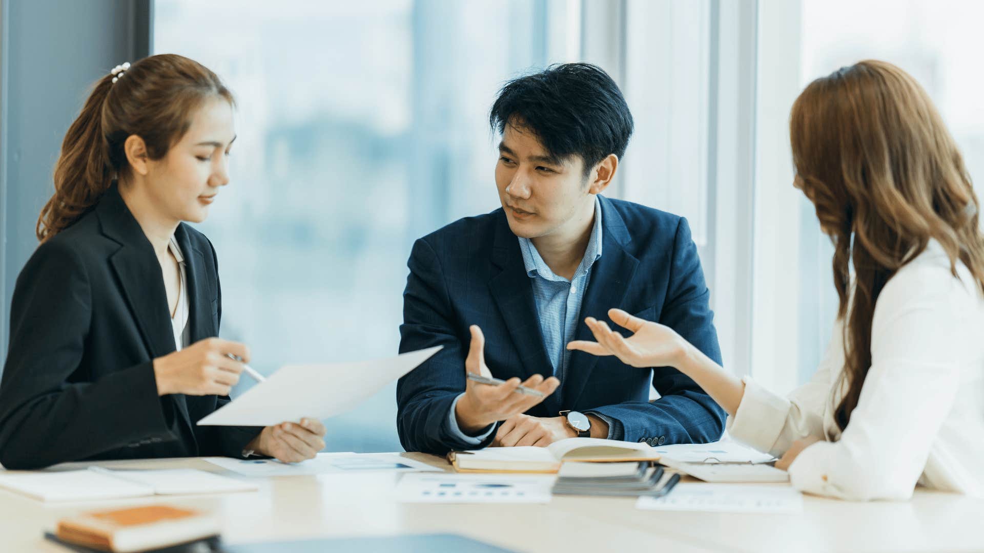 man speaking to co-workers in meeting