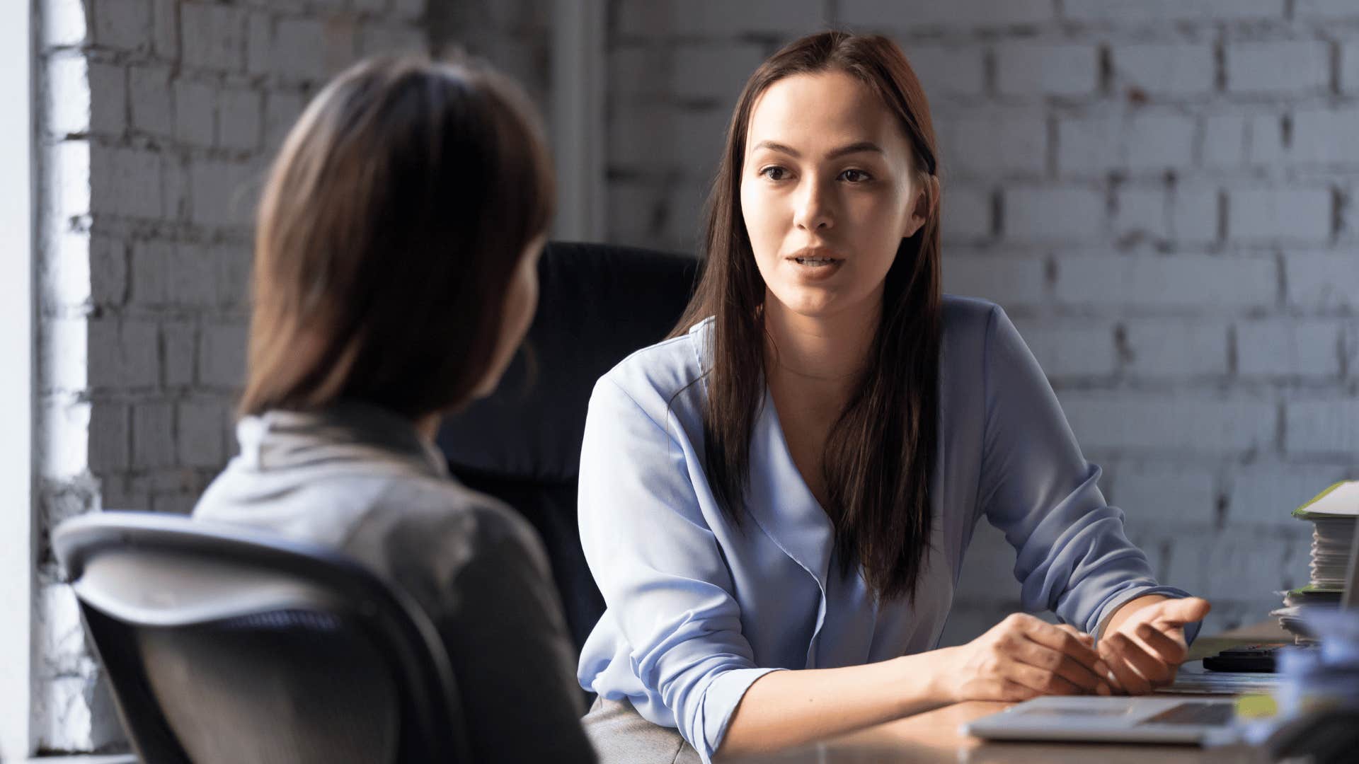 two professional women in a meeting discussion