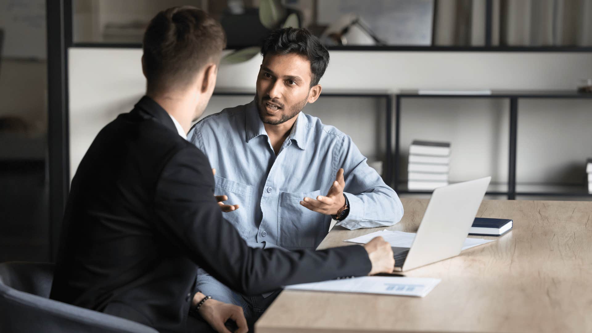 professional man talking to co-worker about efficiency