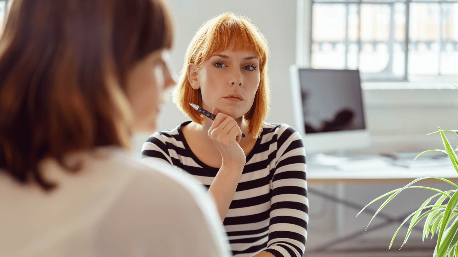 serious woman talking to colleague