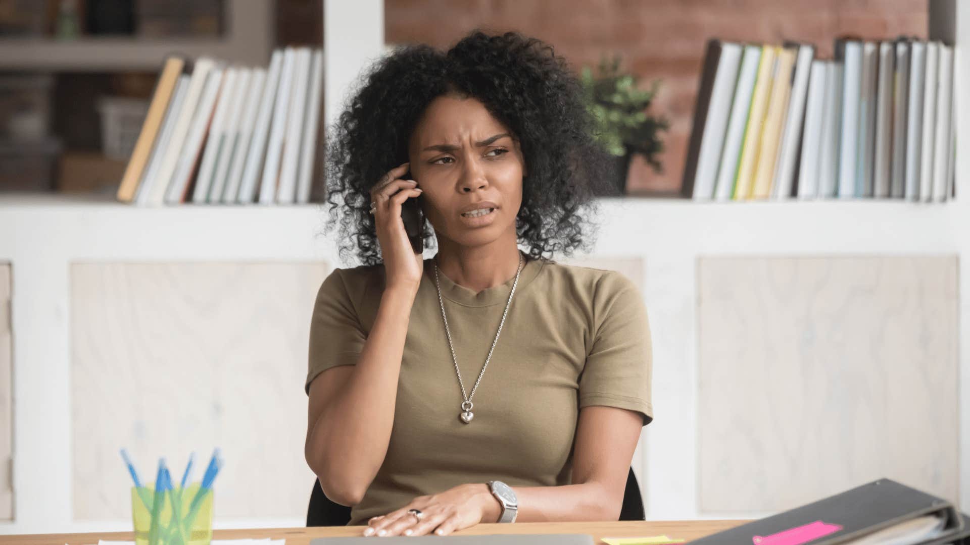 frustrated woman on the phone with work colleague