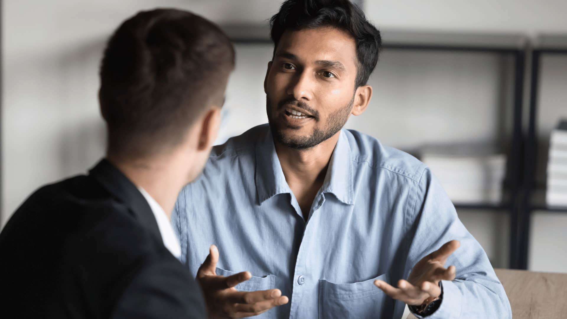 upset man disagreeing with co-worker