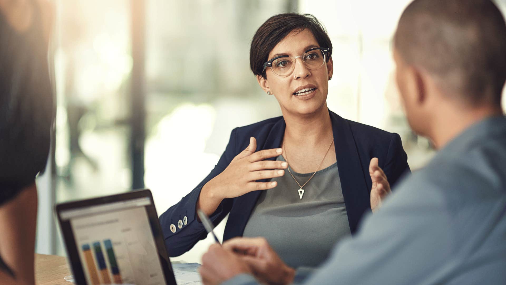 professional woman having work discussion with male colleague