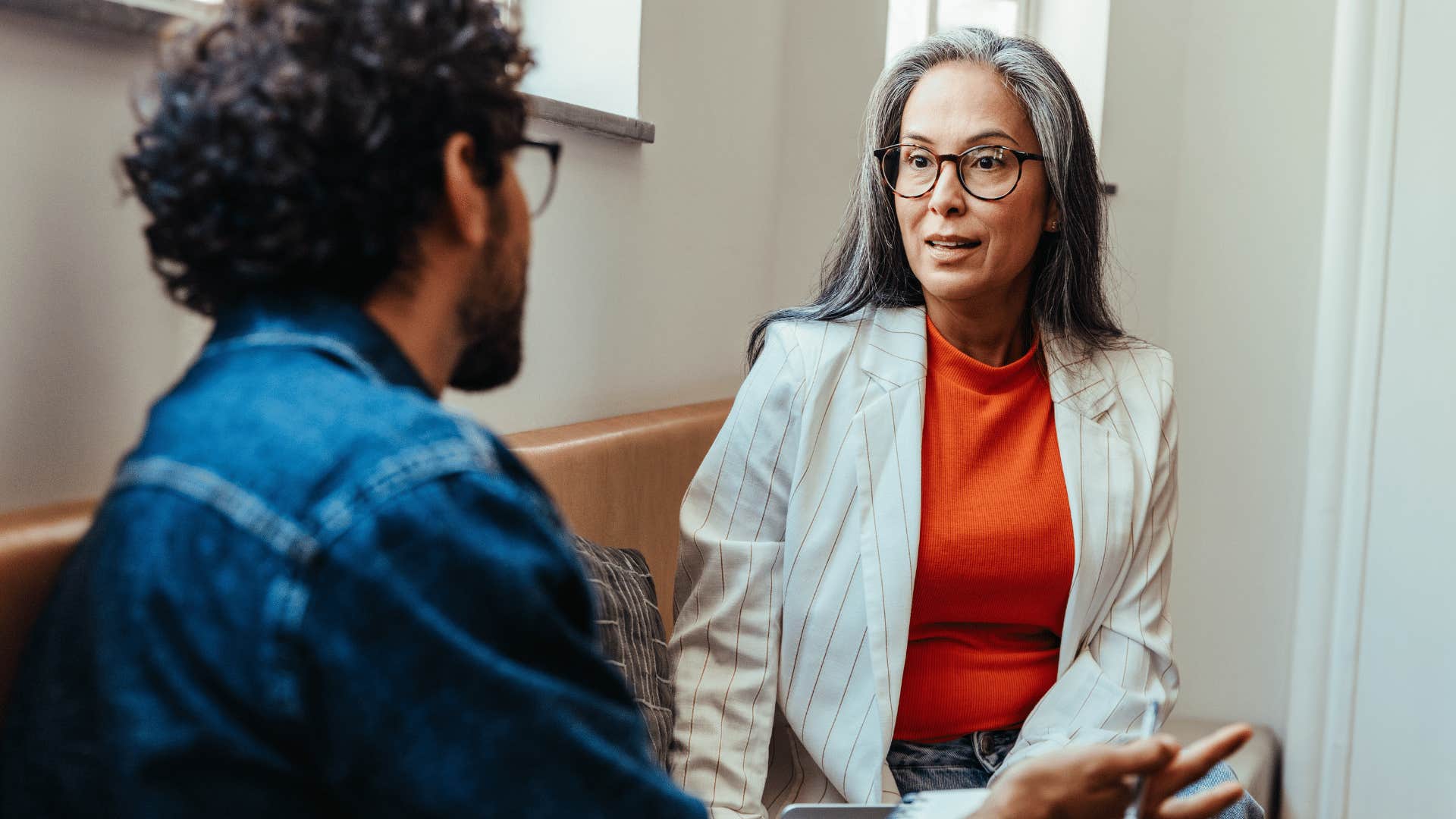 serious professional woman asking co-workers thought process