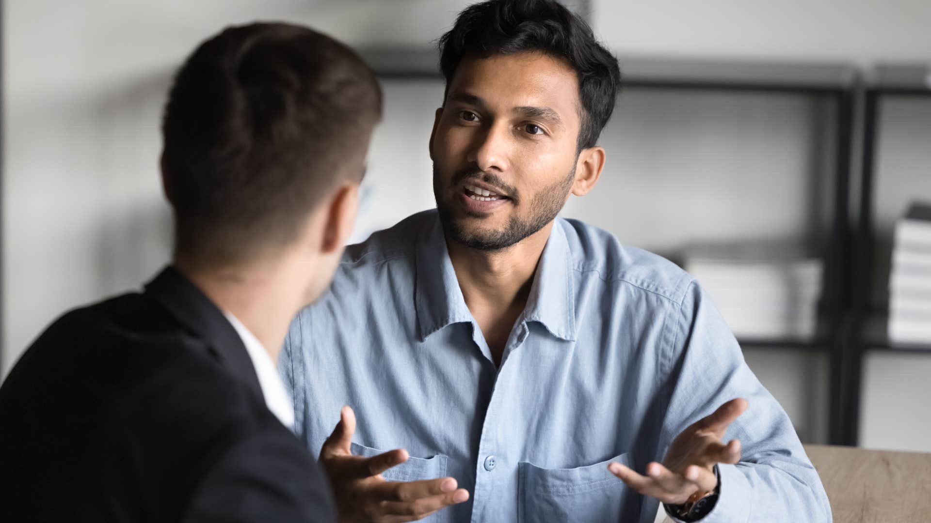 man telling peer they dont see eye to eye at work