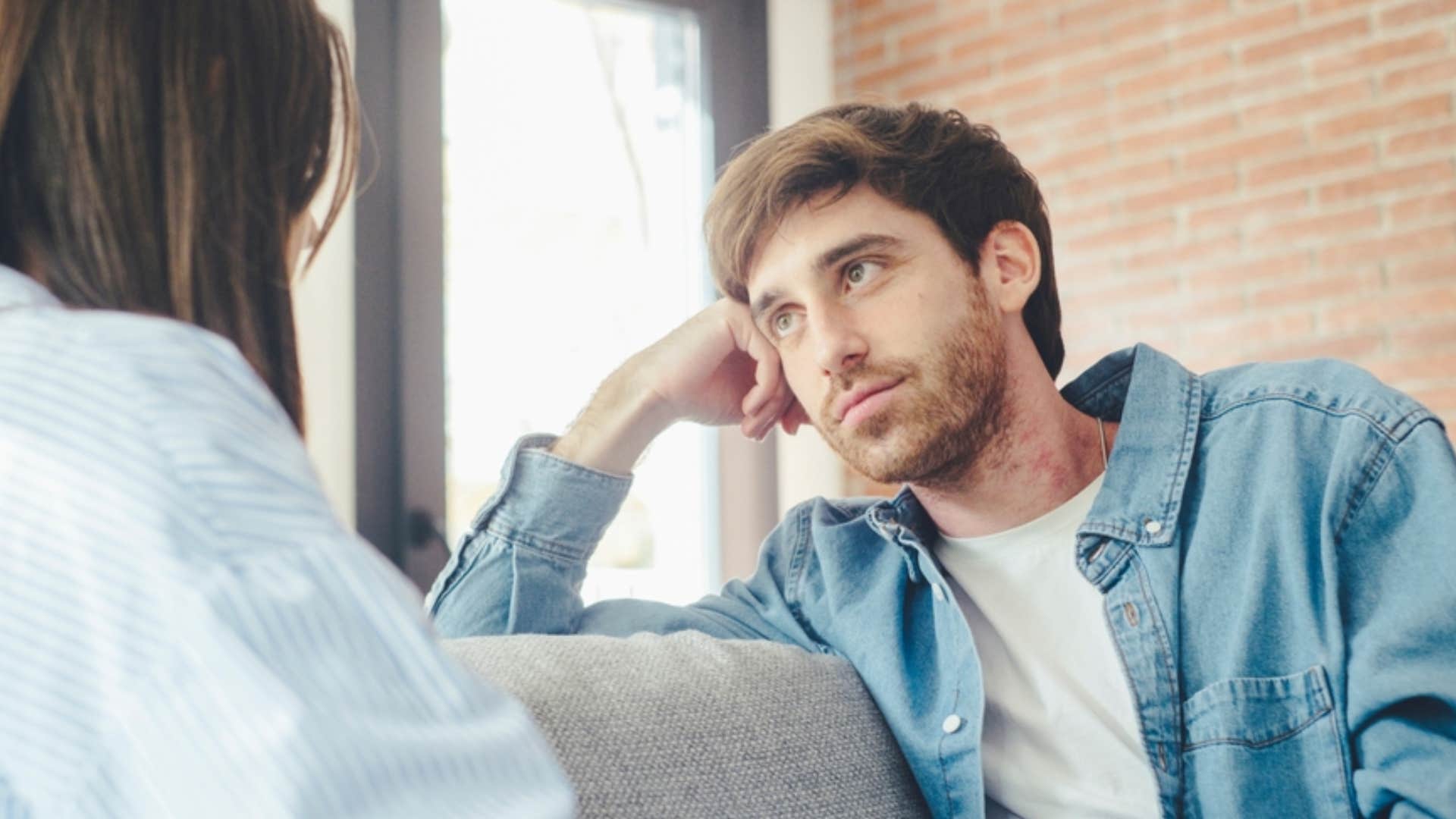 man looking concerned talking to woman