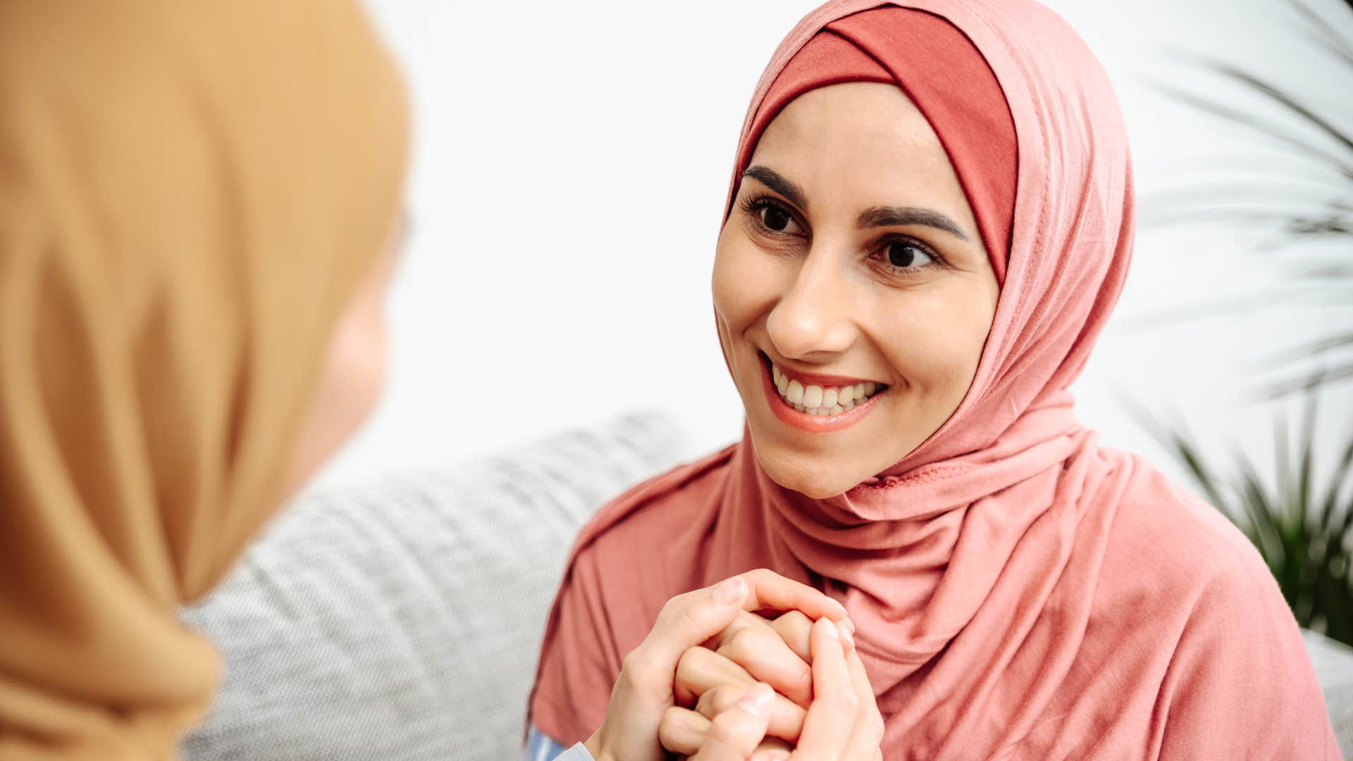 woman smiling and hearing her sister speak