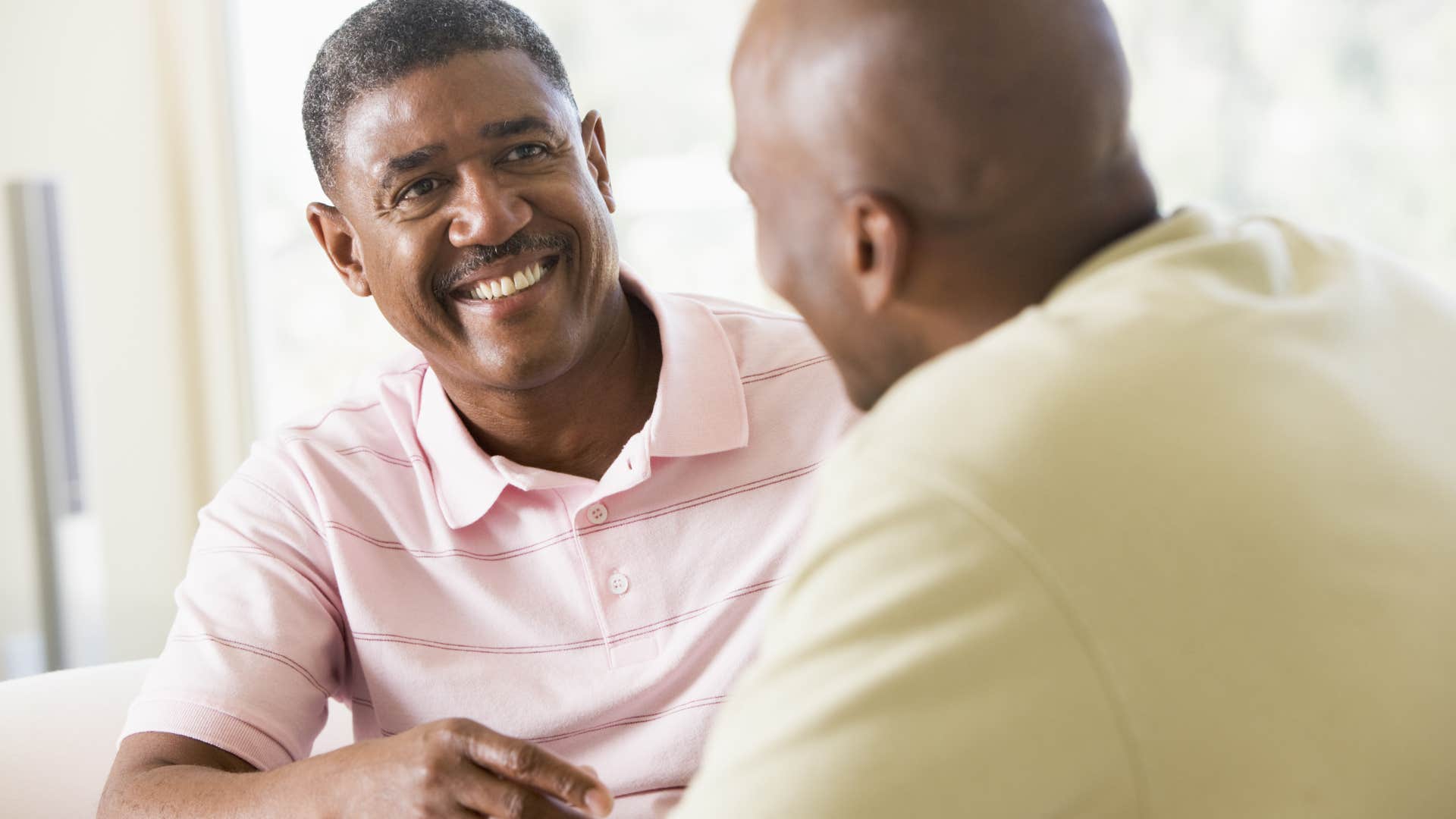 two men having productive conversation smiling