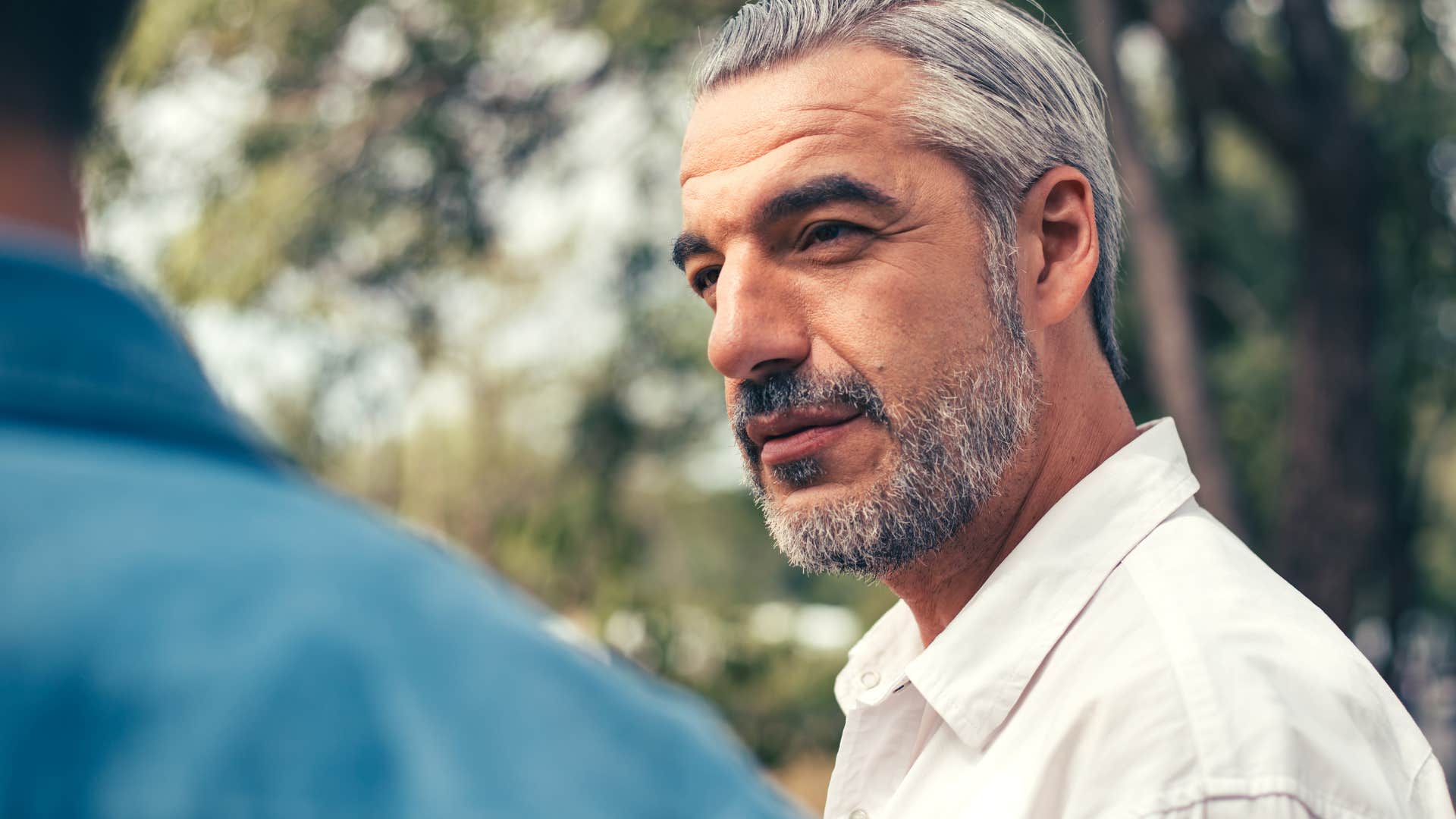 man listening intently as friend shares his thoughts