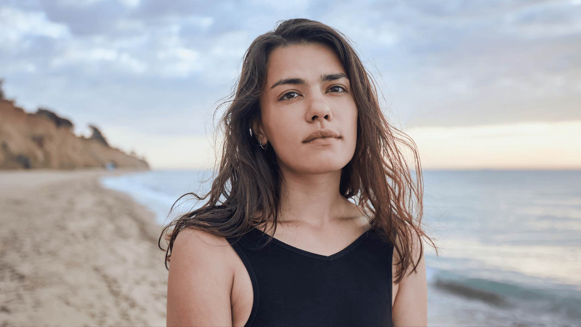 woman in black standing on the beach building the life she wants