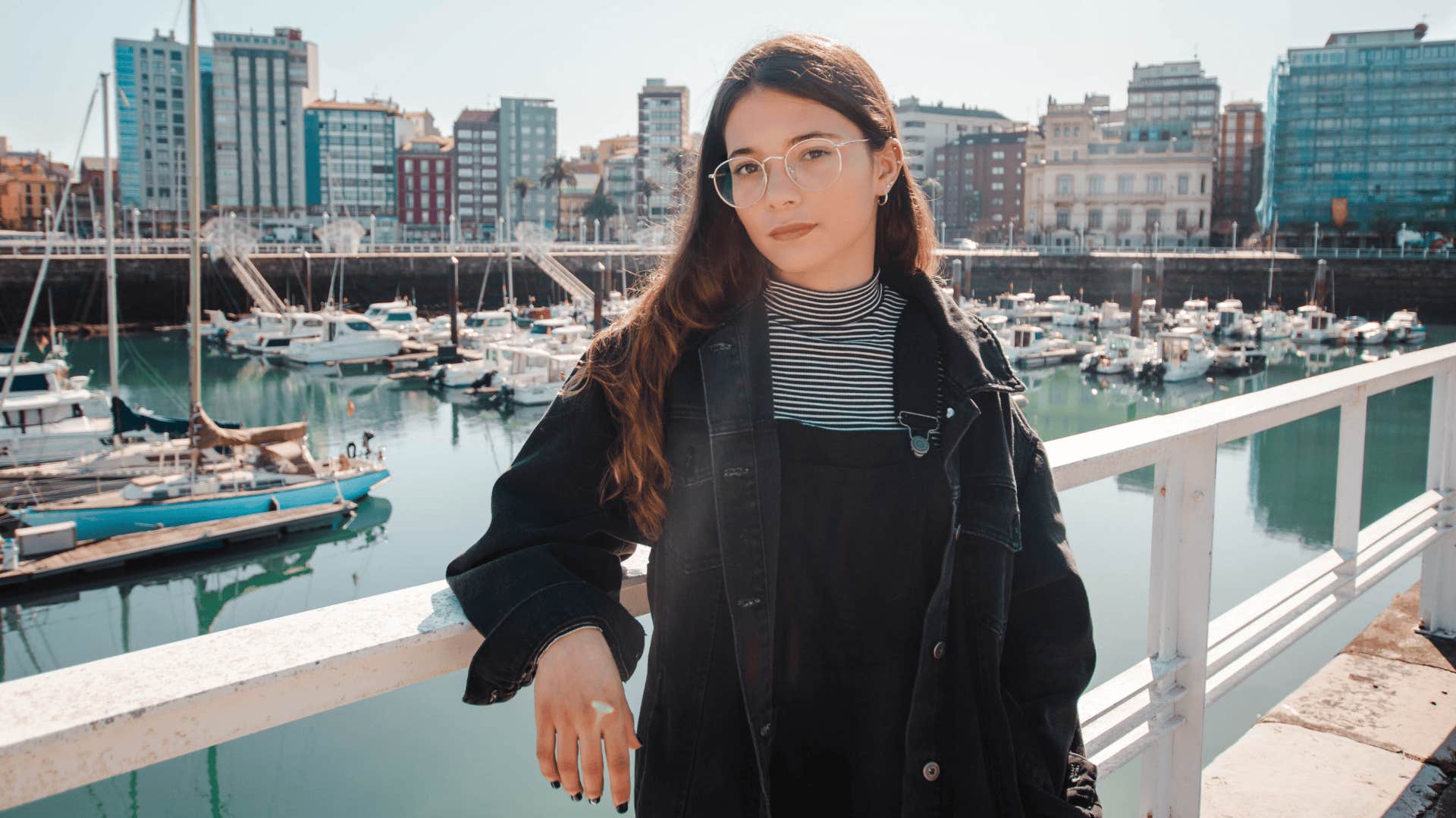 woman standing by a marina thinking she is ready for anything