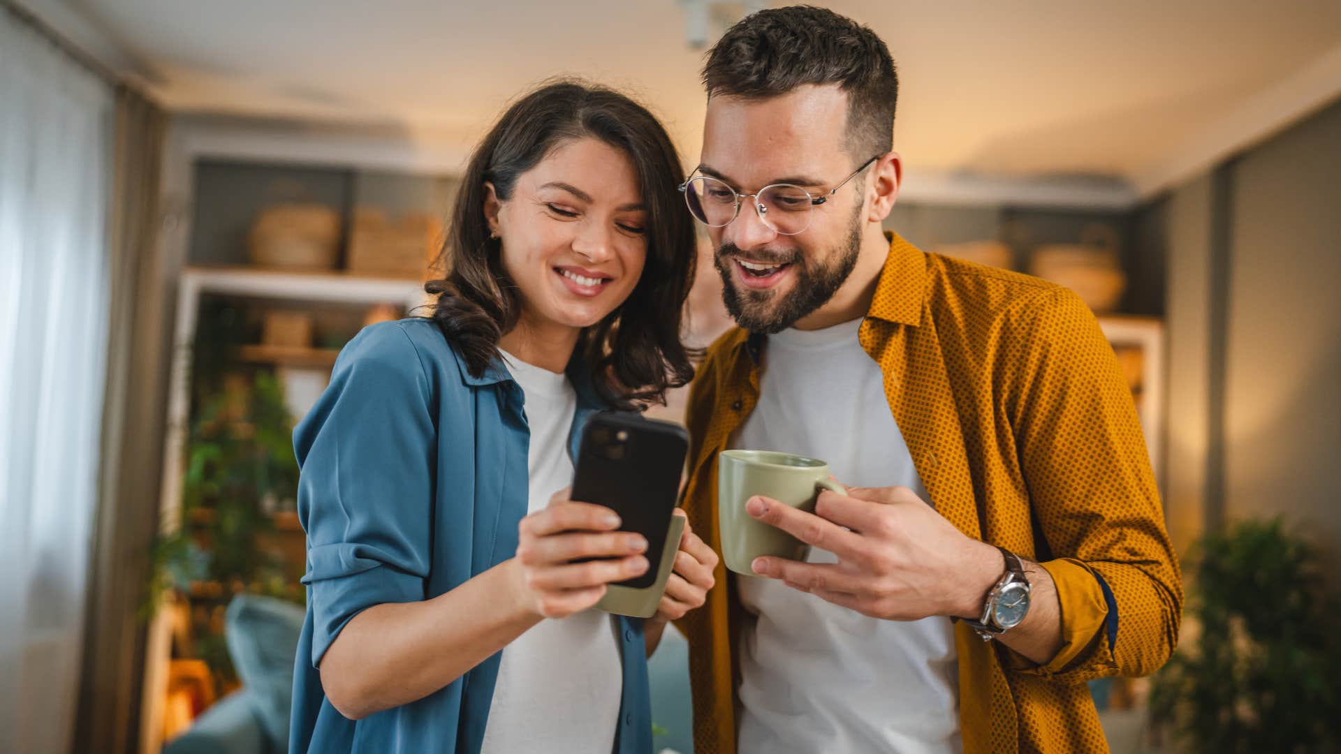 couple figuring out a plan looking at phone and smiling