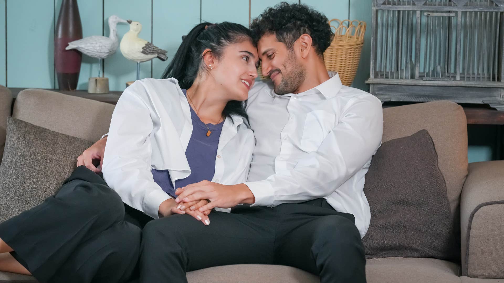 woman and man cuddling on the couch