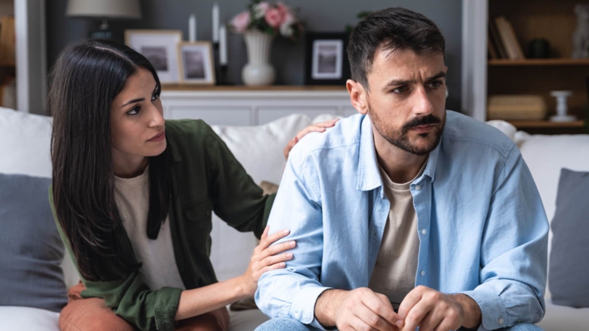 woman trying to comfort emotionally checked out man looking sad