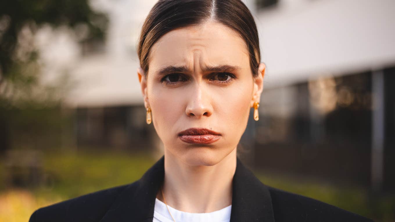 Phrases Overly Defensive People Use Often, According To Psychology defensive woman with a frown on her face