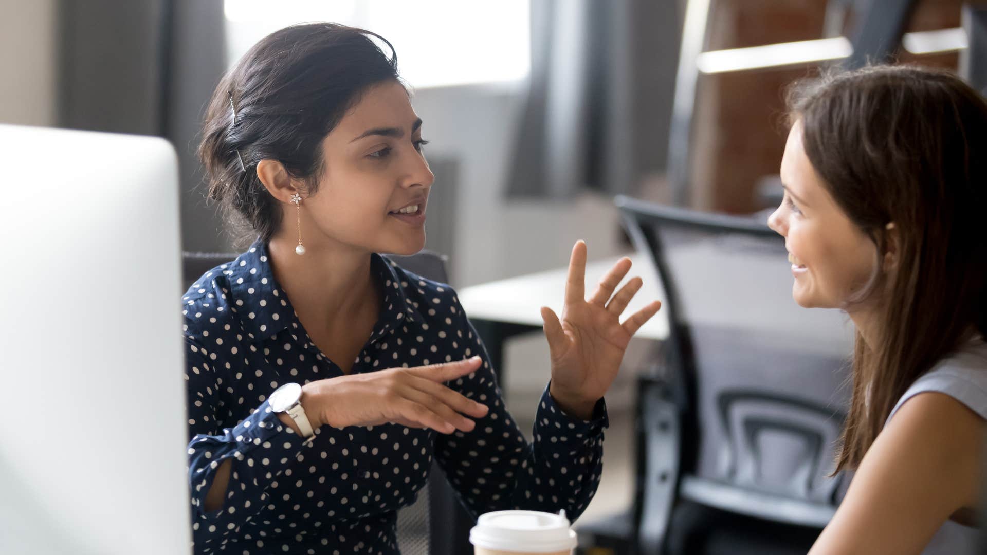 woman explaining moving parts of the company to worker